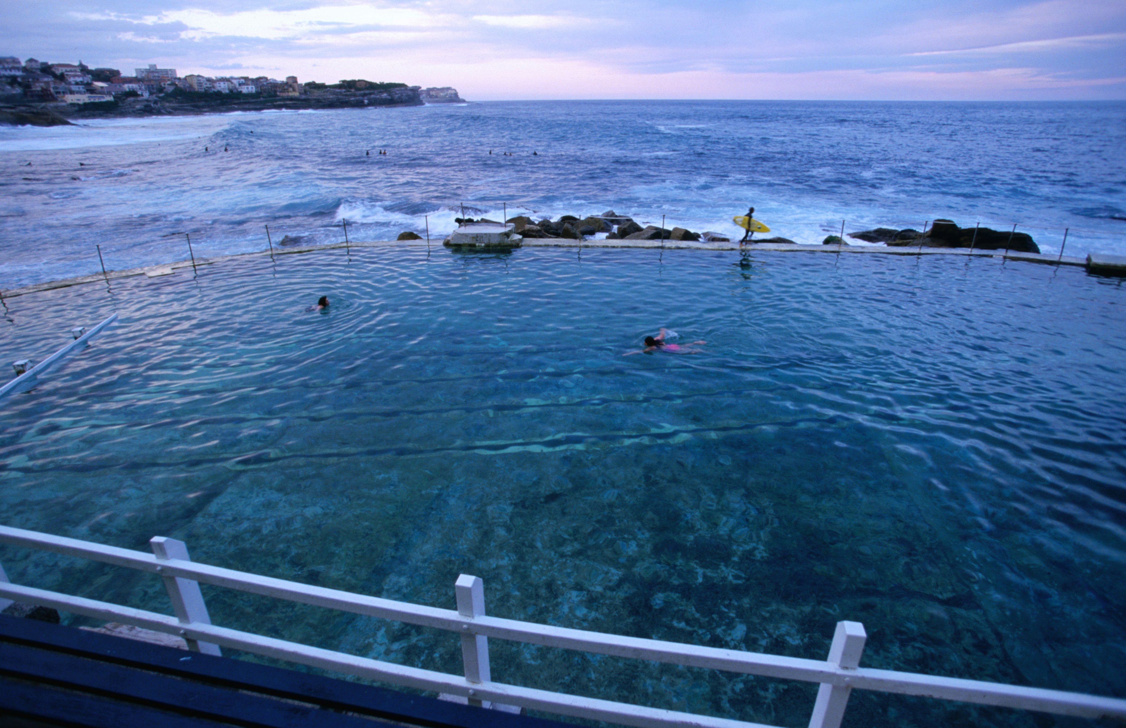 Bronte Baths and beach with two swimmers at sunset