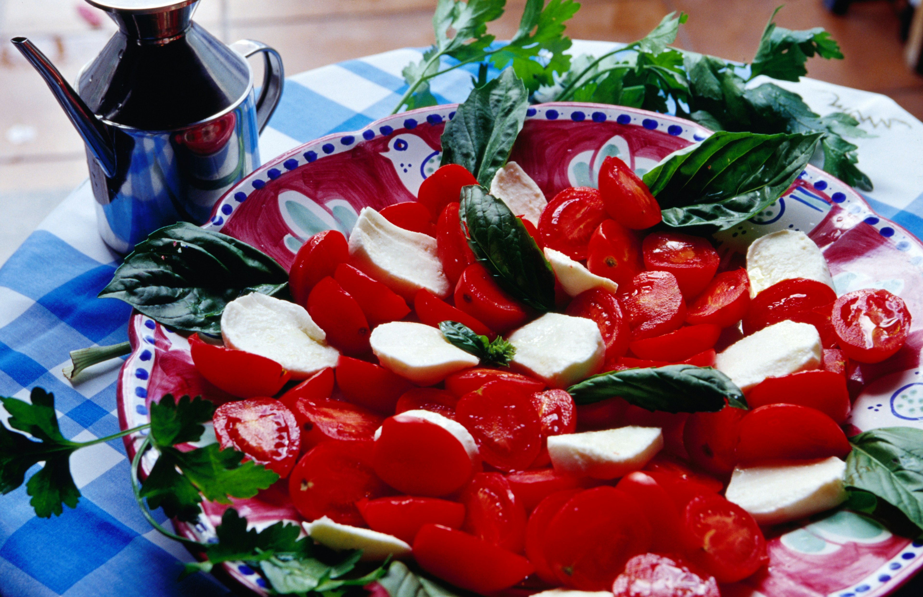 Insalata caprese, on a blue and white table.