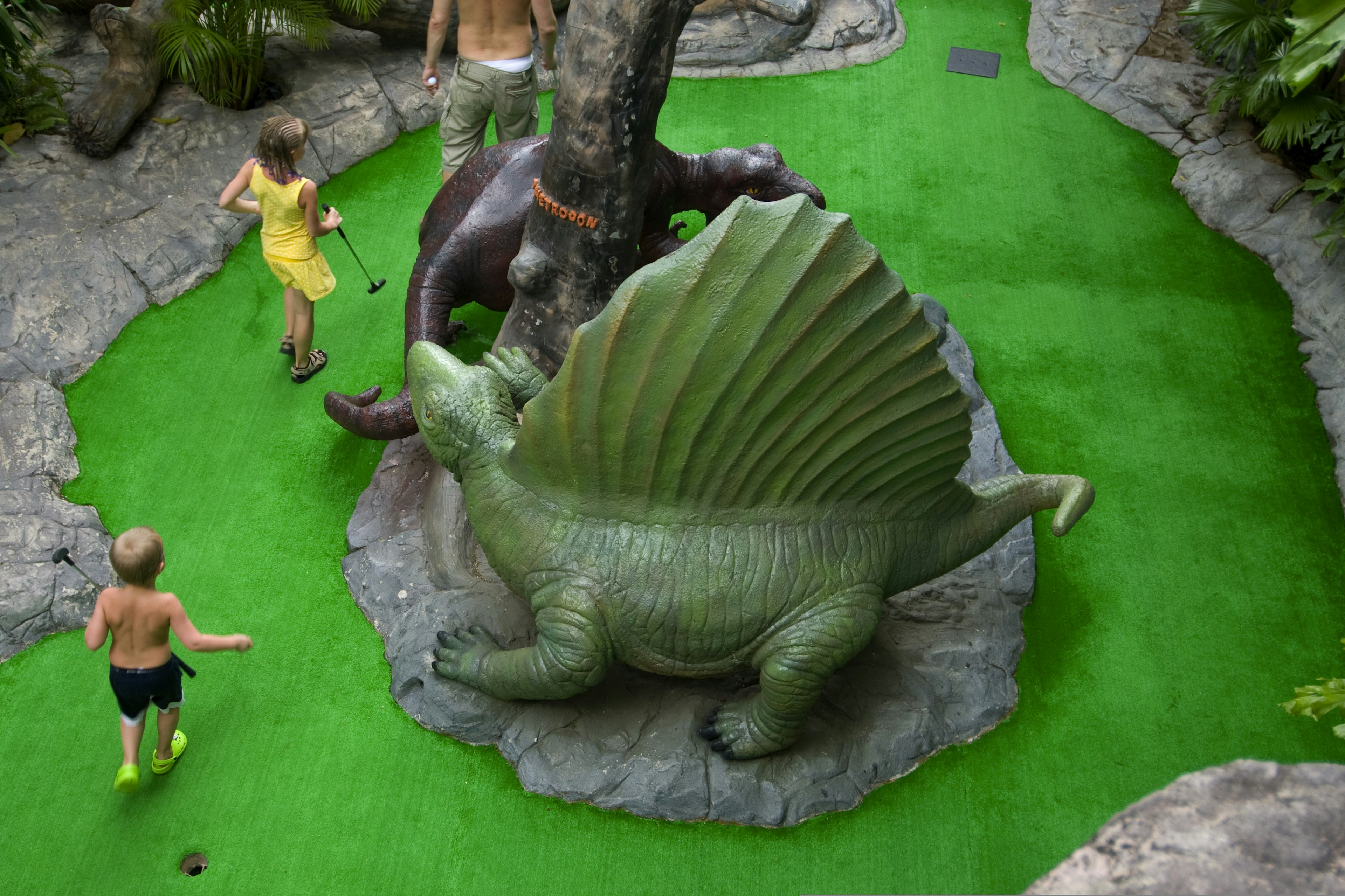 Large dinosaur models are around a miniature golf course in Phuket, Thailand.