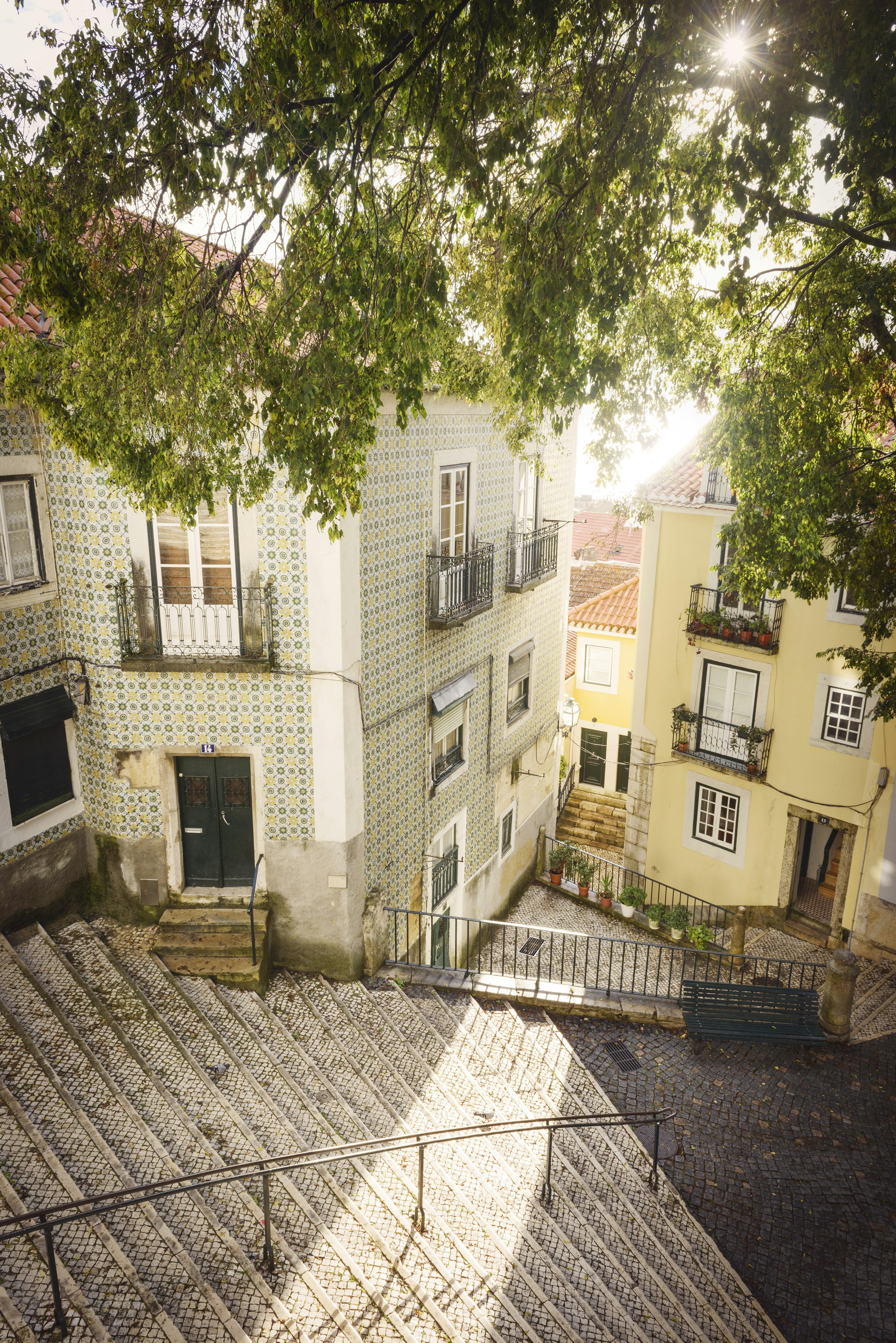 A downward angle of empty public steps surrounded by colourful buildings