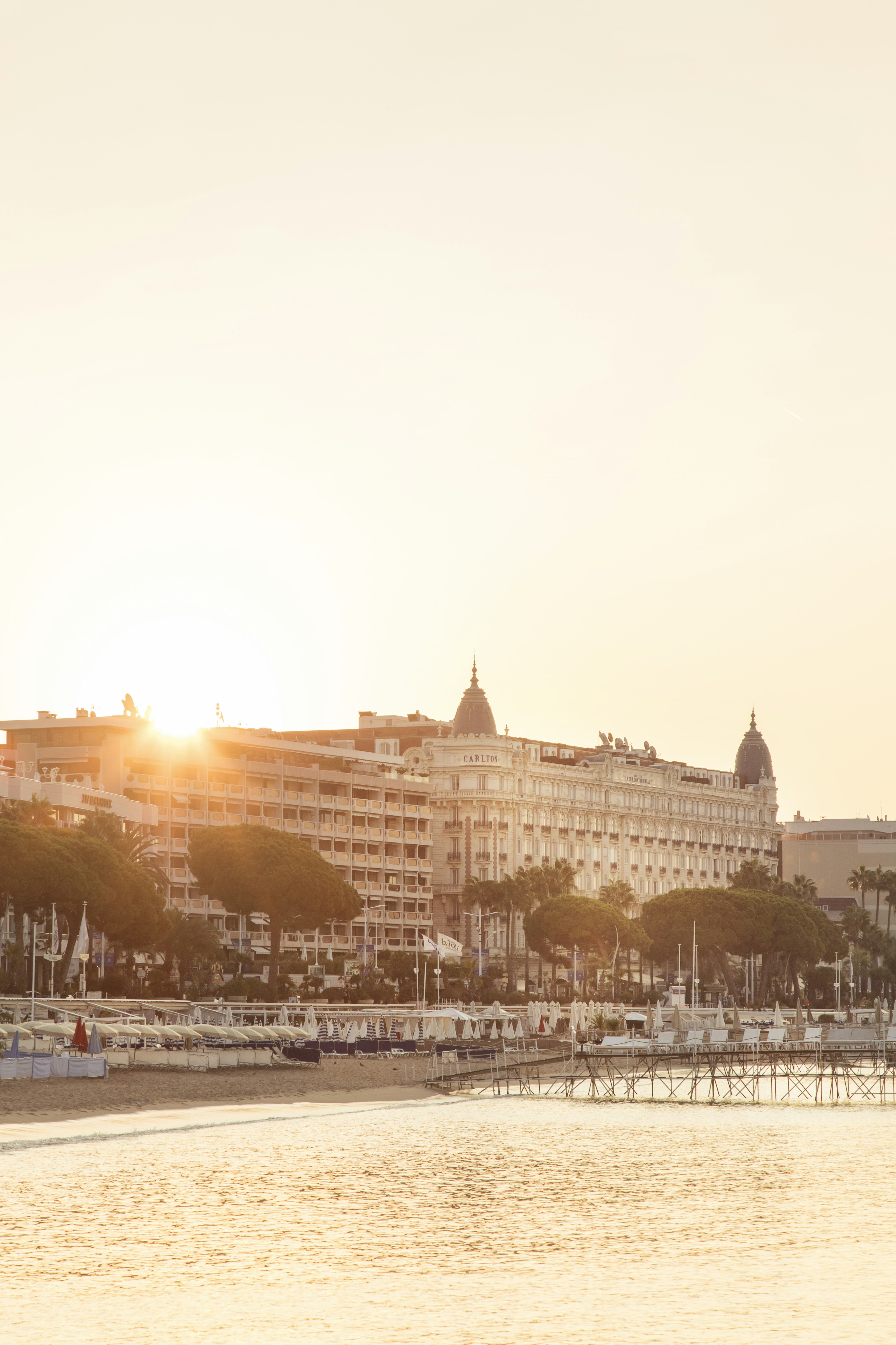 The sun breaks over the roof of the InterContinental Carlton in Cannes