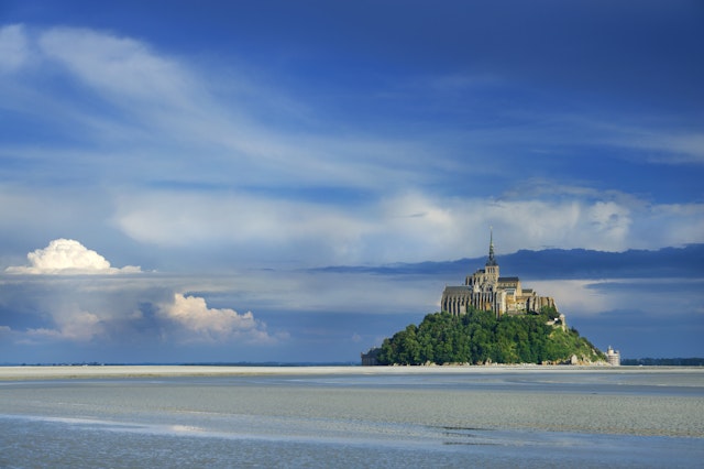 Mont St-Michel at mouth of Couesnon River at low tide.