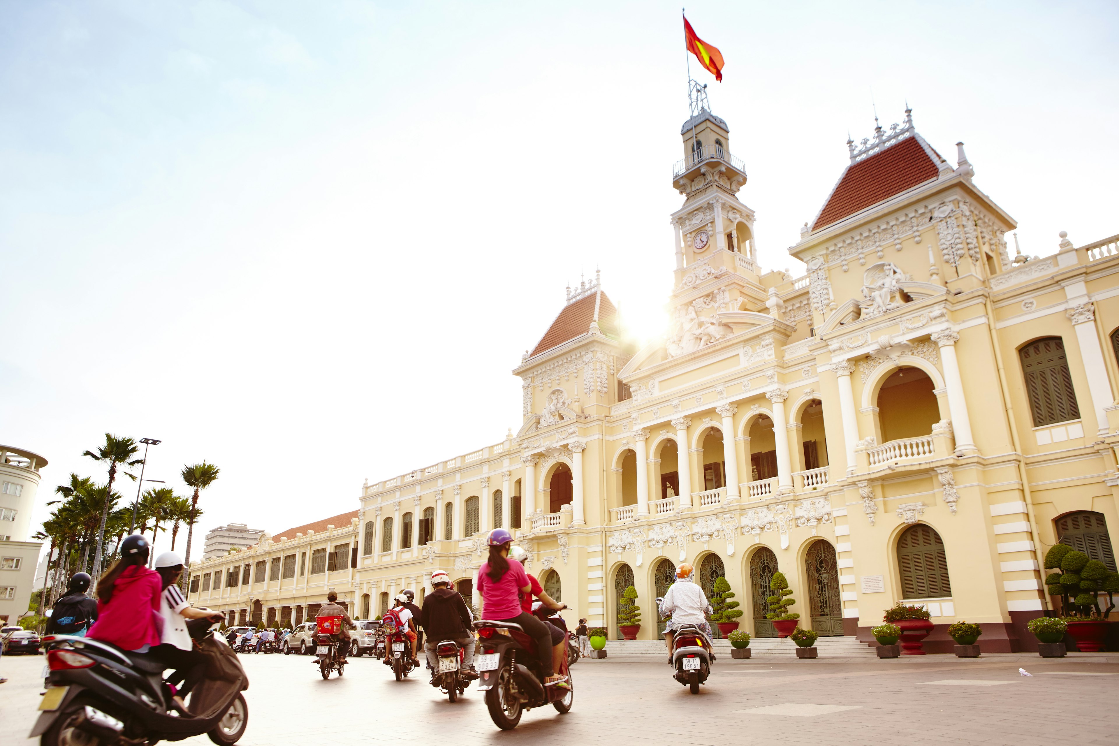 Scooters buzz passed Saigon’s City Hall.