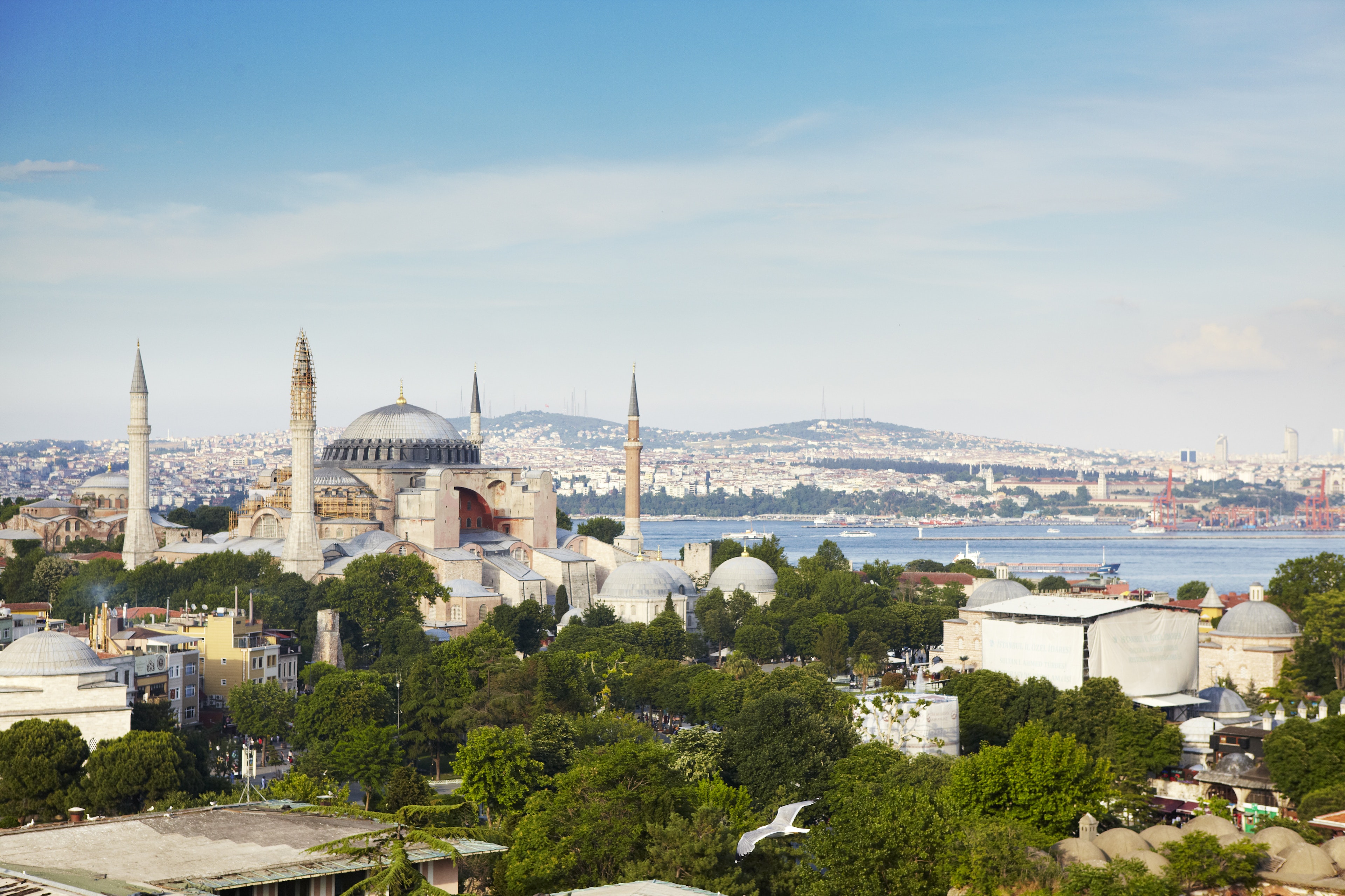 A former church, then mosque (now museum) with a central dome and four minarets dominates the shot with a wide river in the background