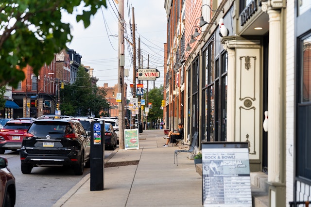A neighborhood street in Pittsburgh features a bowling alley and shops