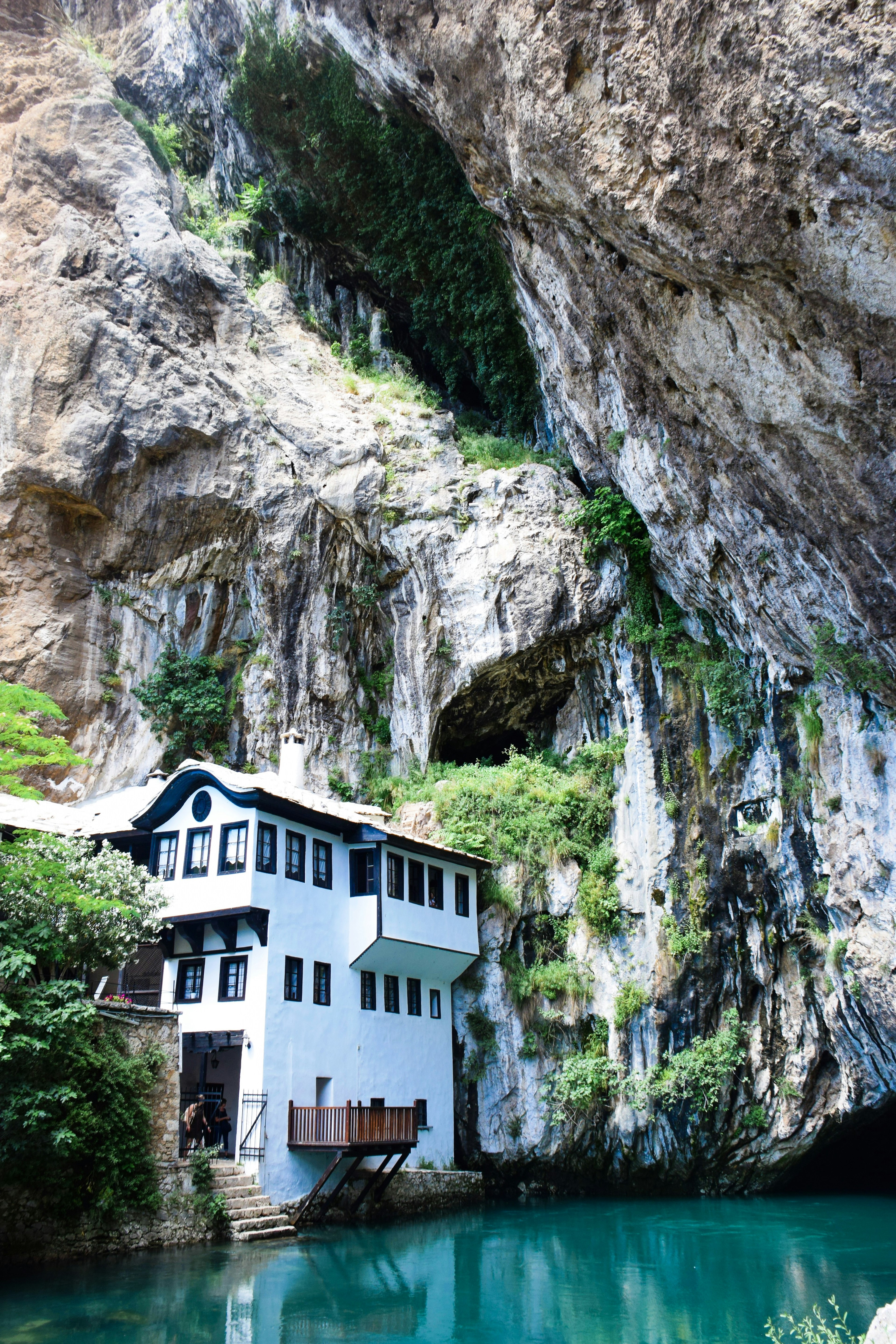 The Blagaj Tekija sits by the River Buna, overshadowed by precipitous cliffs