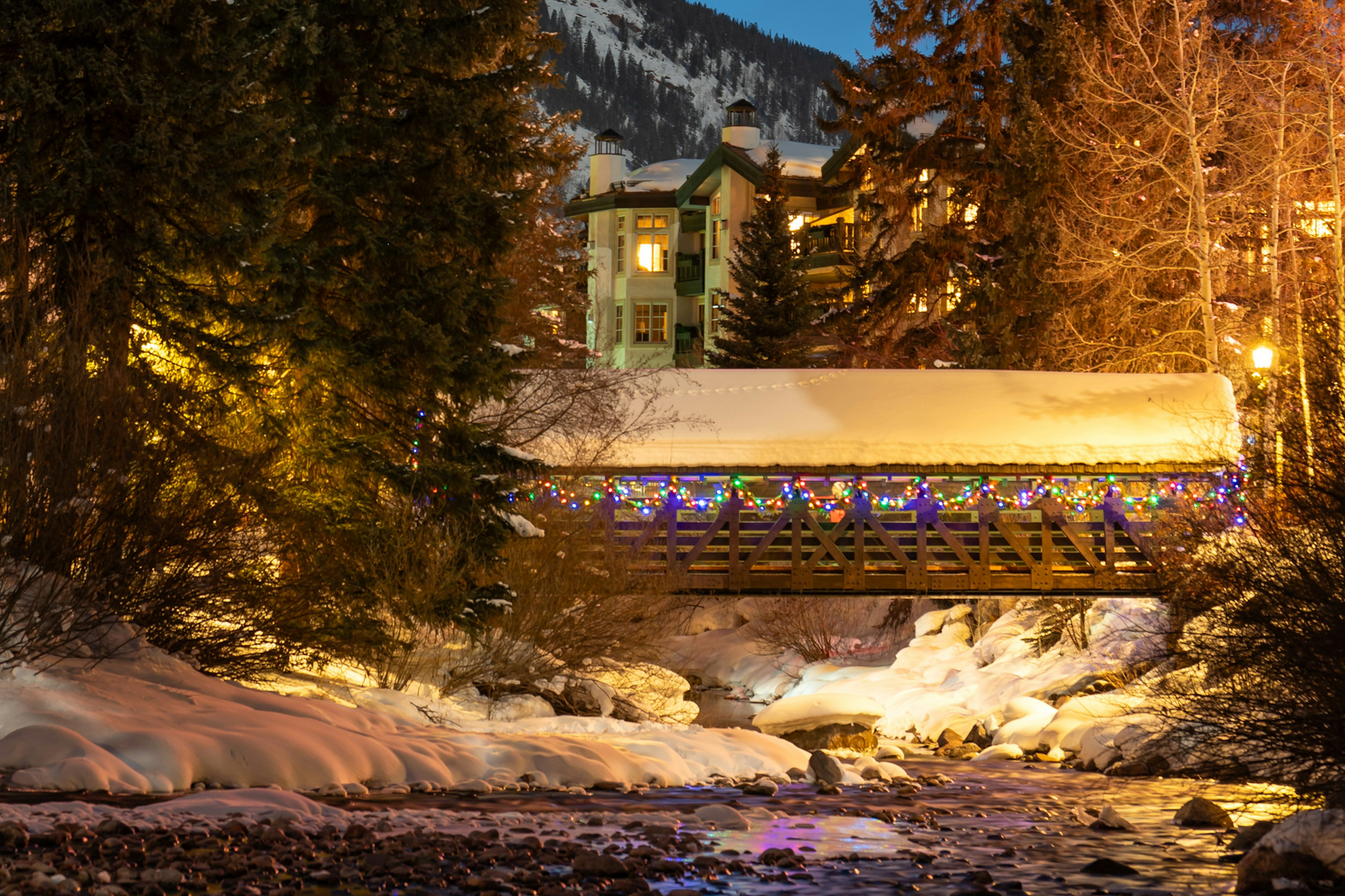 Bridge over river in Vail Village lit up for winter
A covered bridge in the snow in Vail.