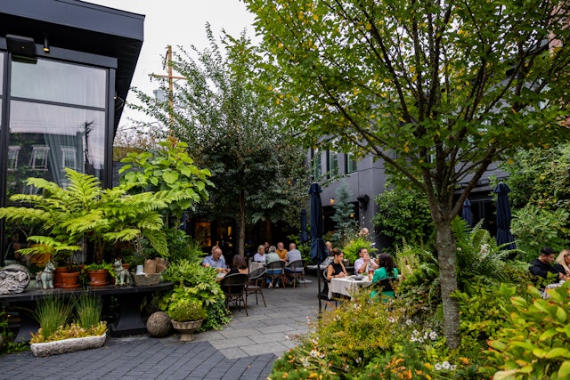The shaded patio at a restaurant in Pittsburgh, with plenty of trees and diners