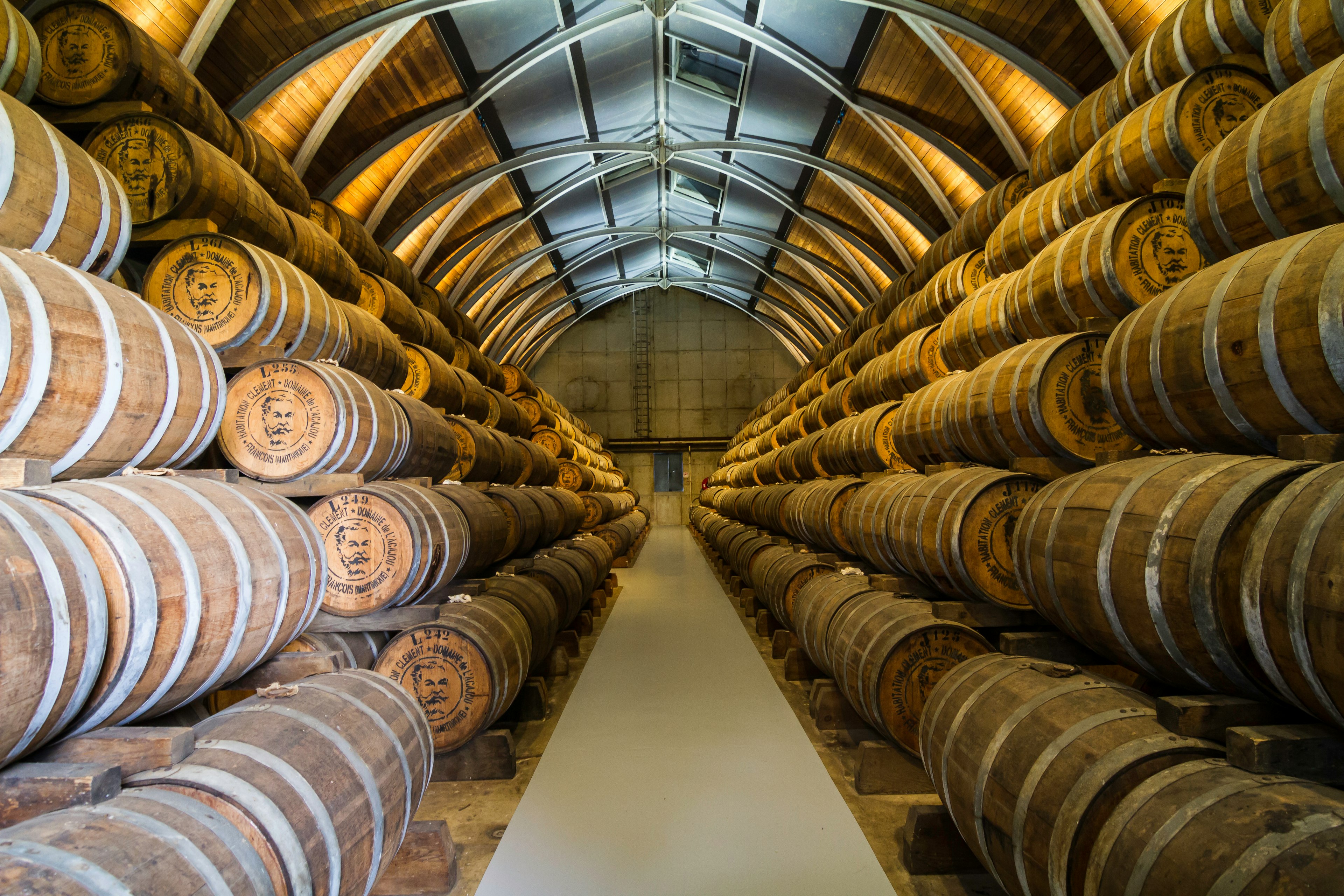 Hundreds of barrels containing rum are arranged in a warehouse at Habitation Clément in Martinique