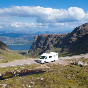 Motorhome parked at the side of the road near Bealach na Ba and Applecross in summer in the Scottish Highlands with blue skies, License Type: media, Download Time: 2024-09-23T21:42:32.000Z, User: robinbarton170, Editorial: false, purchase_order: 56530, job: Global Publishing-WIP, client: Epic Van Trips of Europe 1, other: Robin Barton