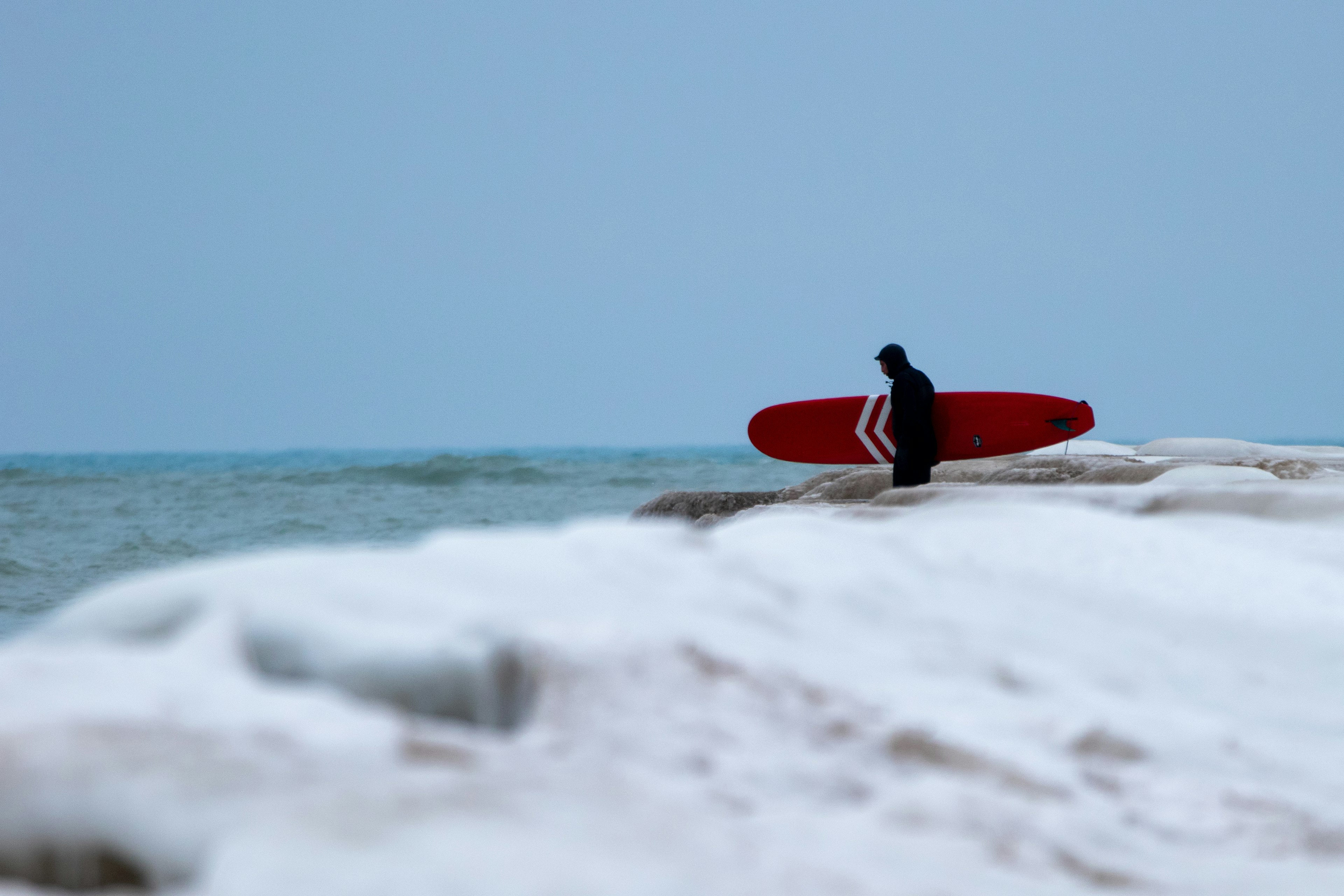 Winter Surfing in Lake Michigan. The Malibu of the Midwest freezes and doesn't stop visitors to the water for a new experience in fresh water surfing.