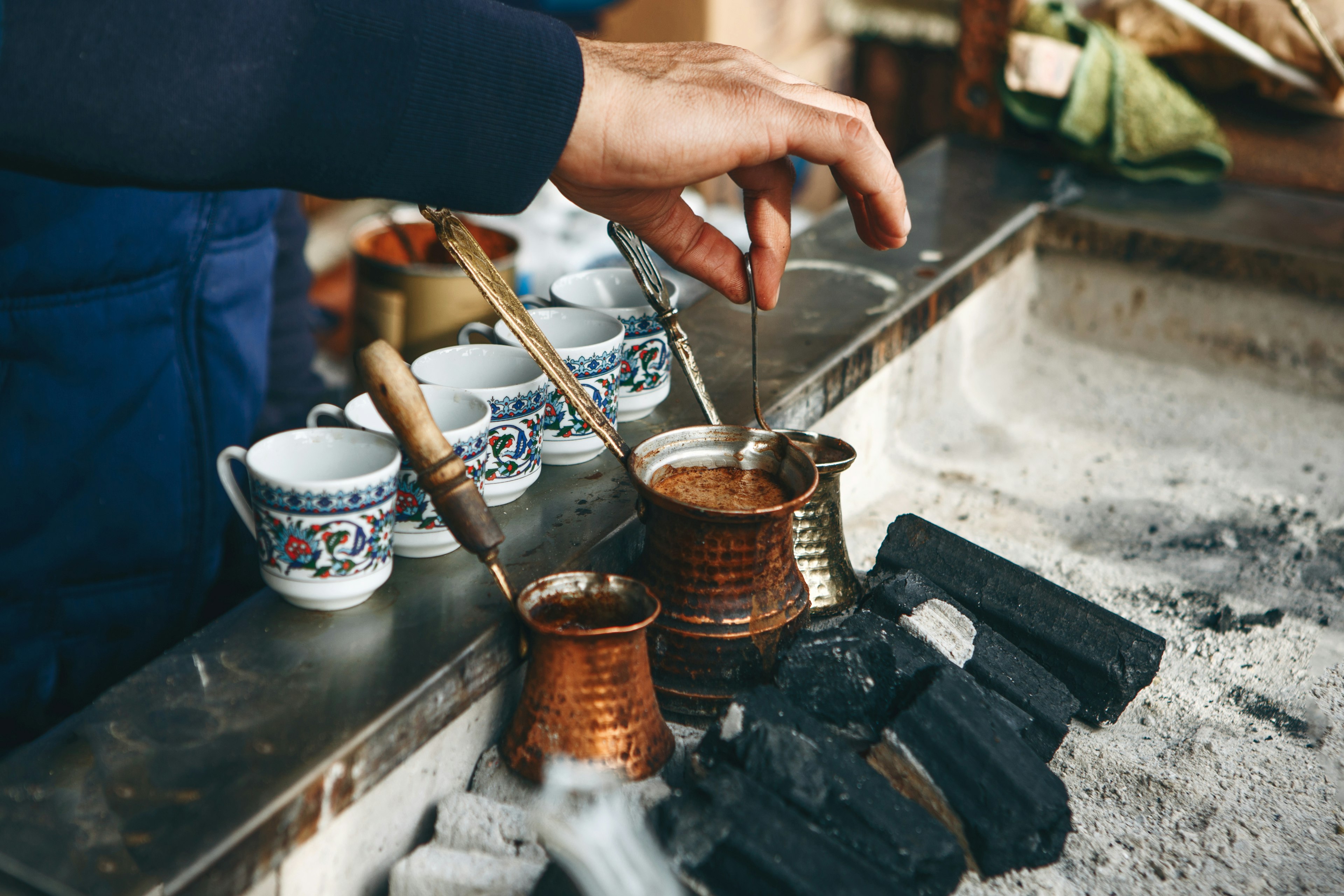 Cooking fresh aromatic traditional Turkish coffee on charcoal.