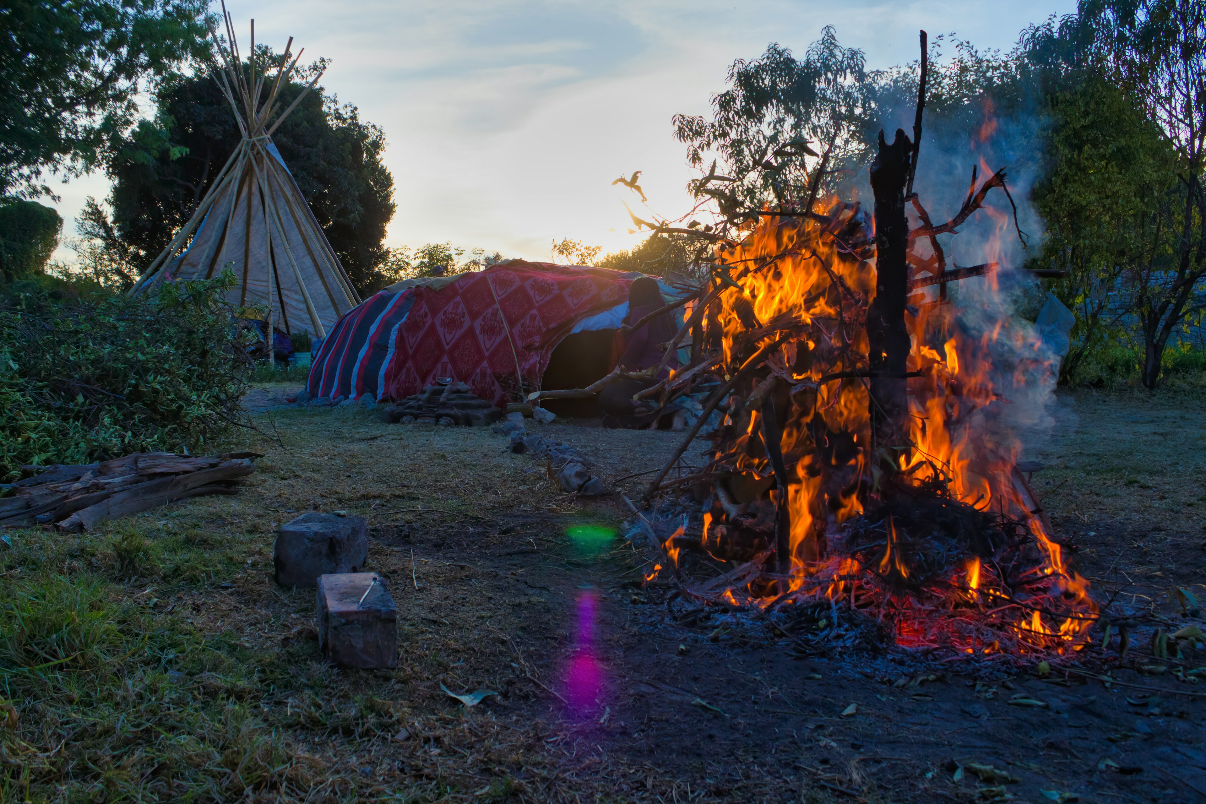 Temazcal or temascal, preparation for ritual in traditional native sweat lodge with hot stones and a fire in foreground in Mexico