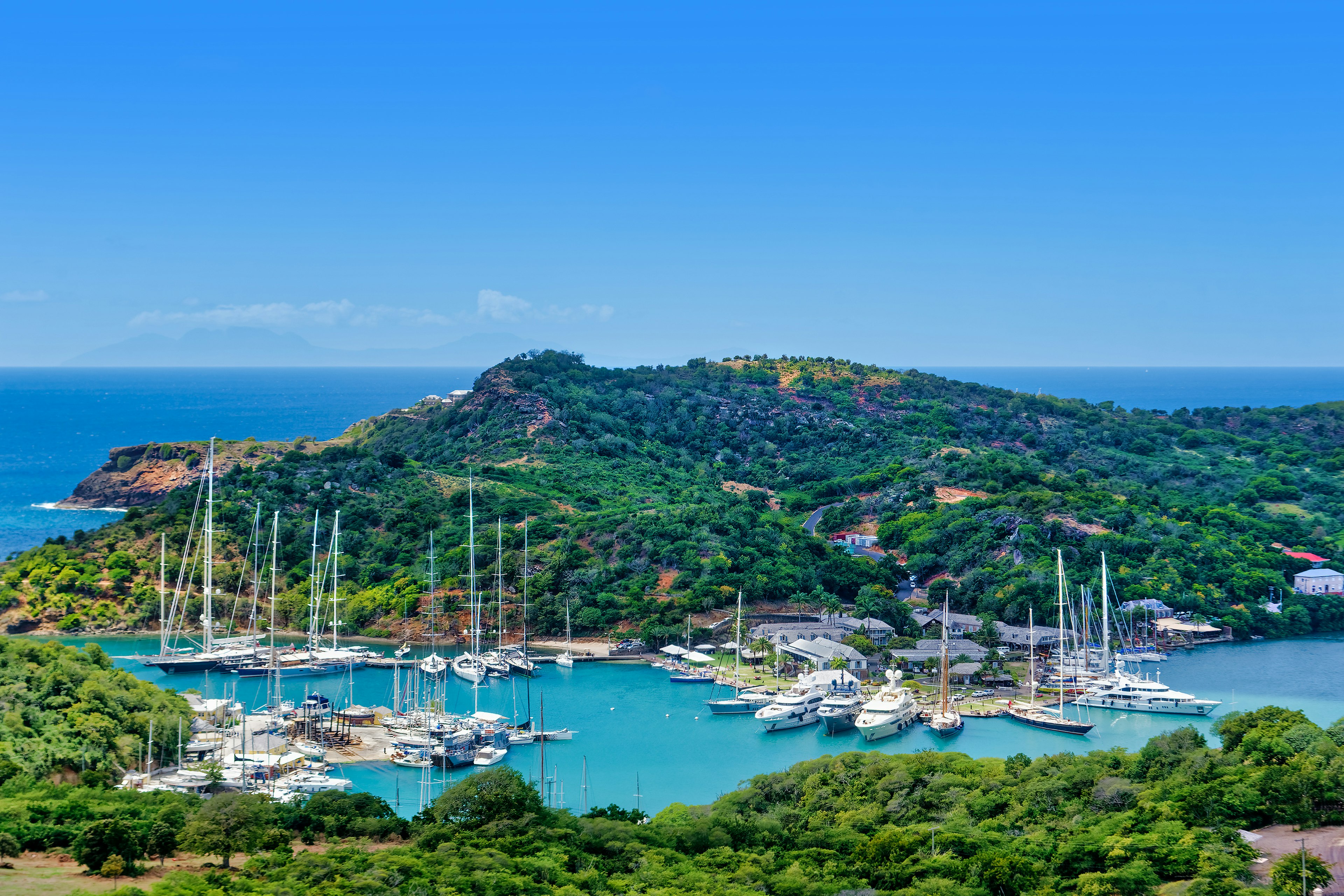 A panoramic view of masted ships and yachts moored at Nelson’s Dockyard National Park, Antigua, Antigua & Barbuda