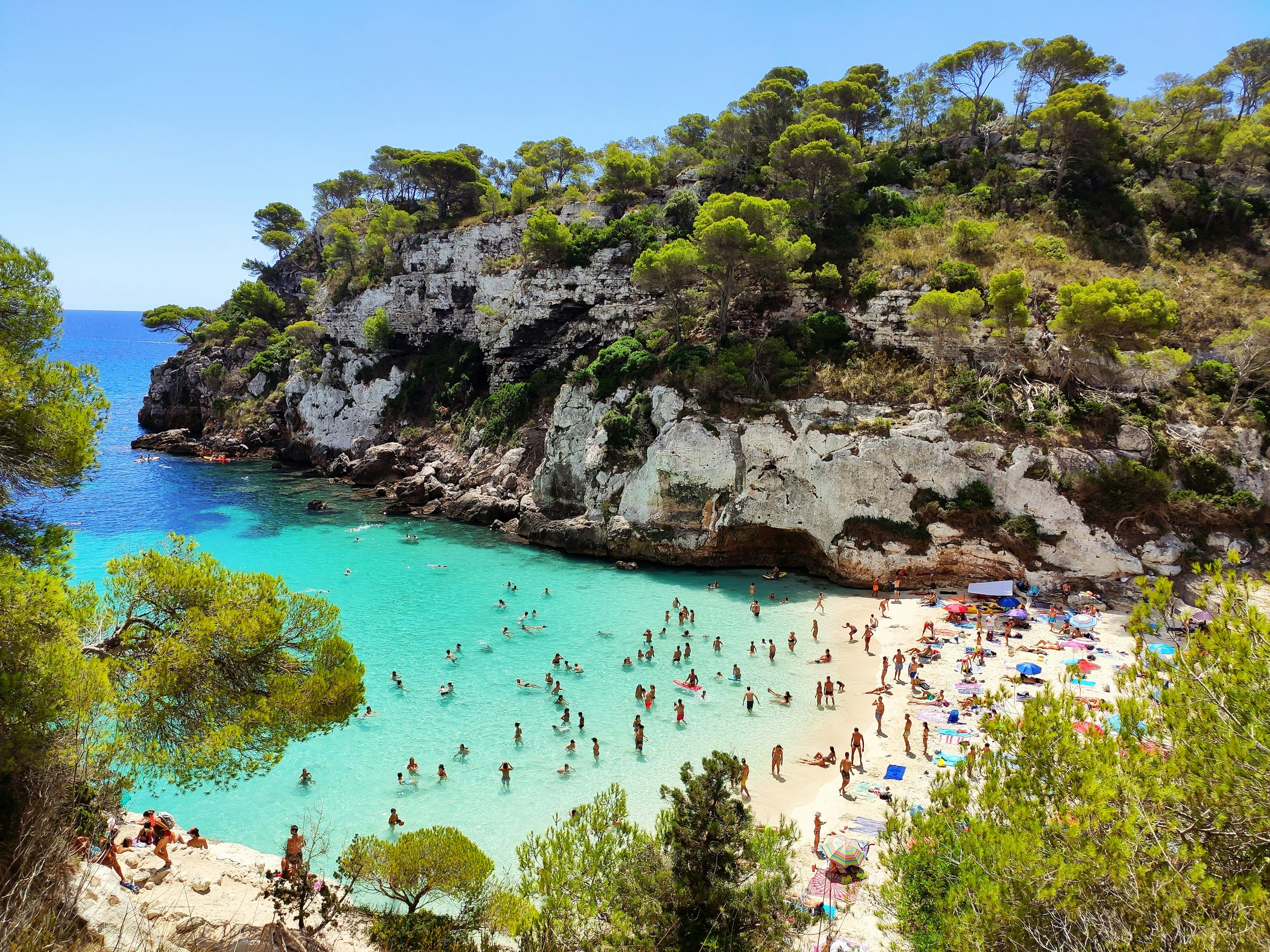 Cala Macarelleta famous paradise beach with turquoise water and pine forests on south coast of Menorca Island, Balearic Islands, Spain.