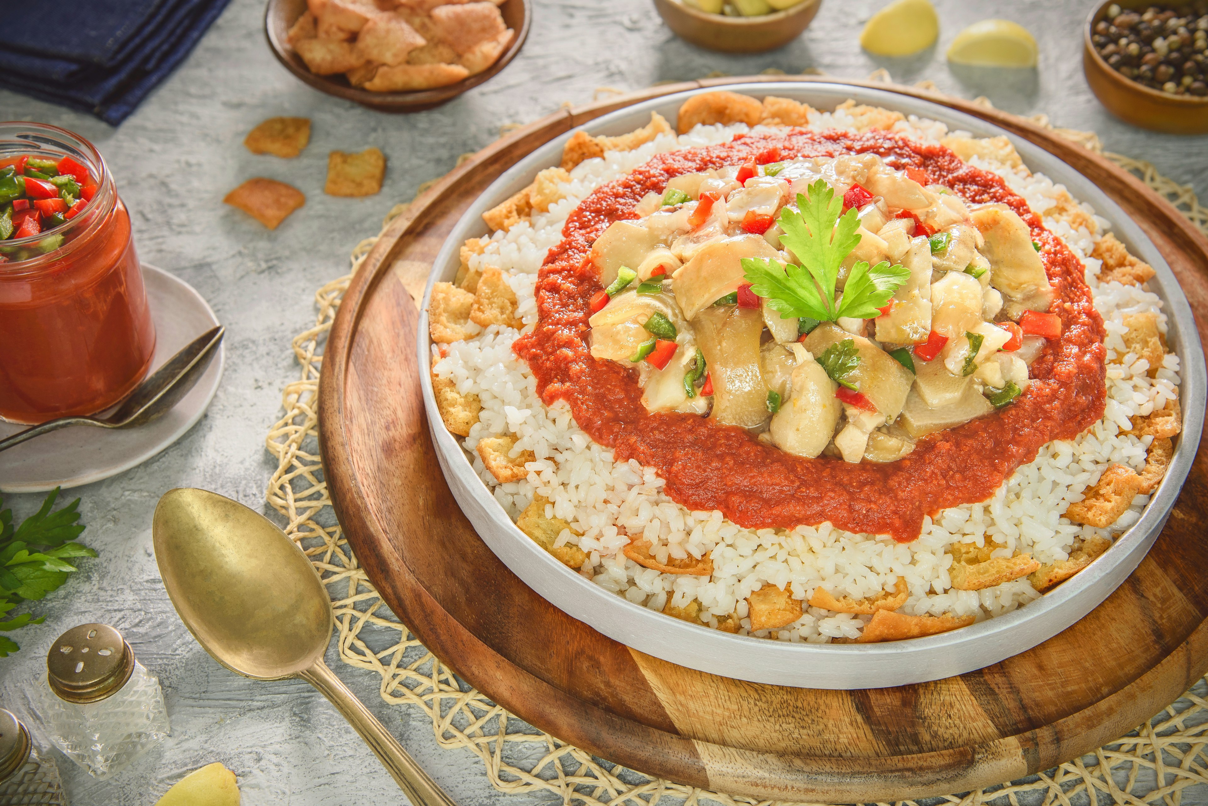 Arabic cuisine; Egyptian oriental Fattah with white rice and crispy bread topped with seasoned garlic red sauce and chunks of boneless trotters.