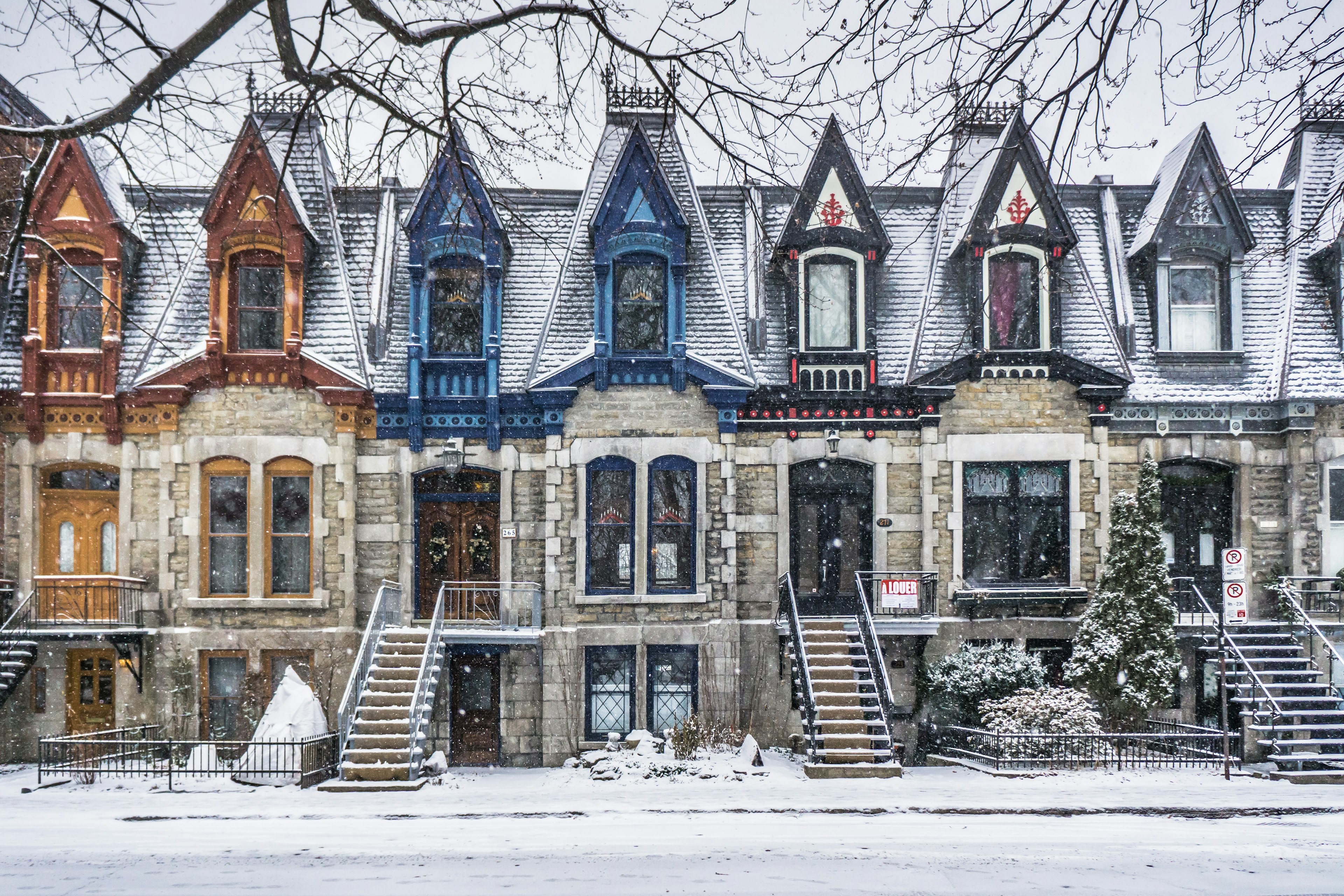 A view of Victorian houses with colorful architectural details on Carré Saint Louis in the Plateau, ѴǲԳٰé, Québec, Canada