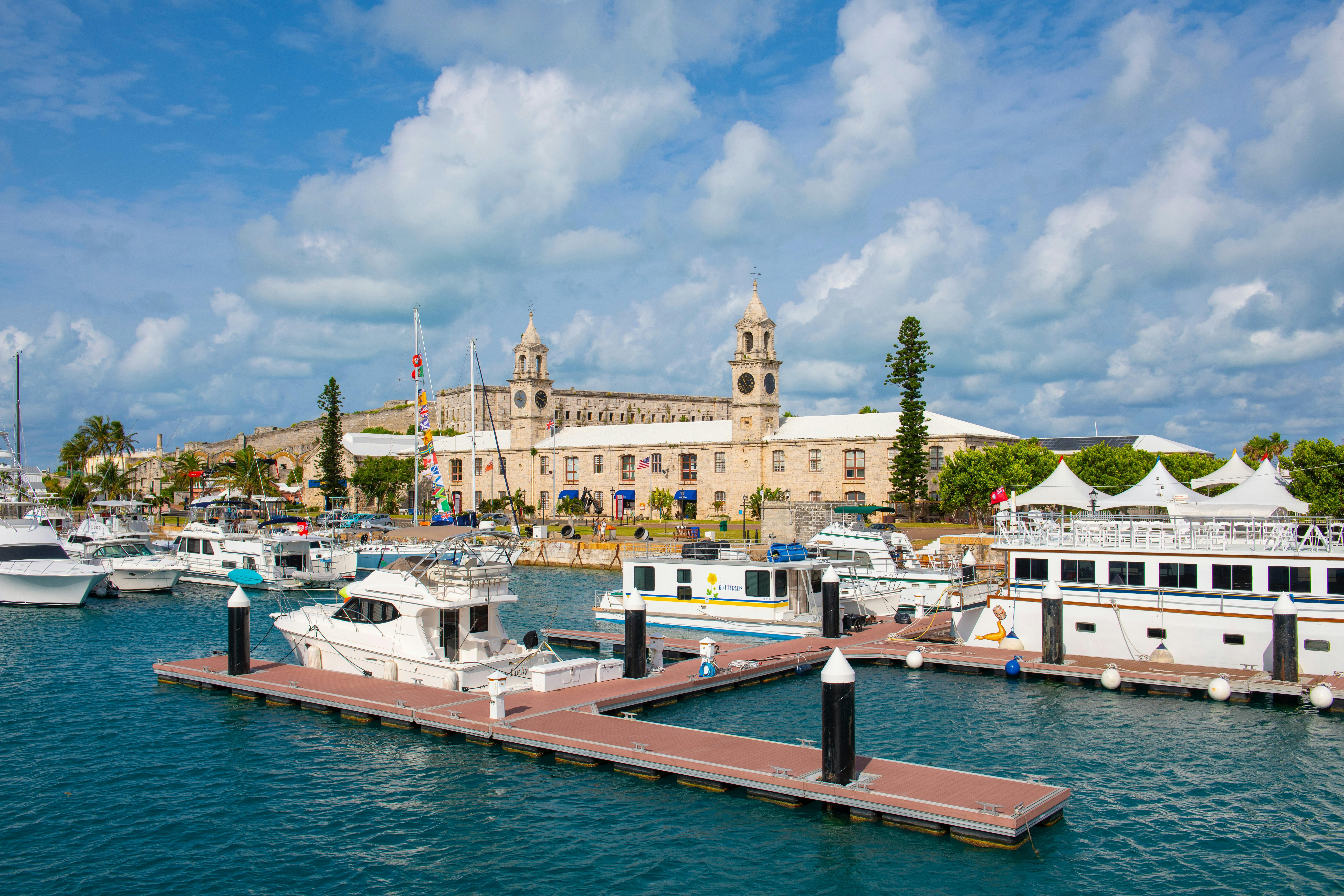 BERMUDA - AUG. 21, 2023: Marina at former Royal Naval Dockyard with Store House Clock Tower at the background in Sandy Parish, Bermuda.