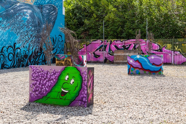 Interesting and colorful artwork painted on planters in a courtyard in the Alberta Arts District in Portland, Oregon, USA