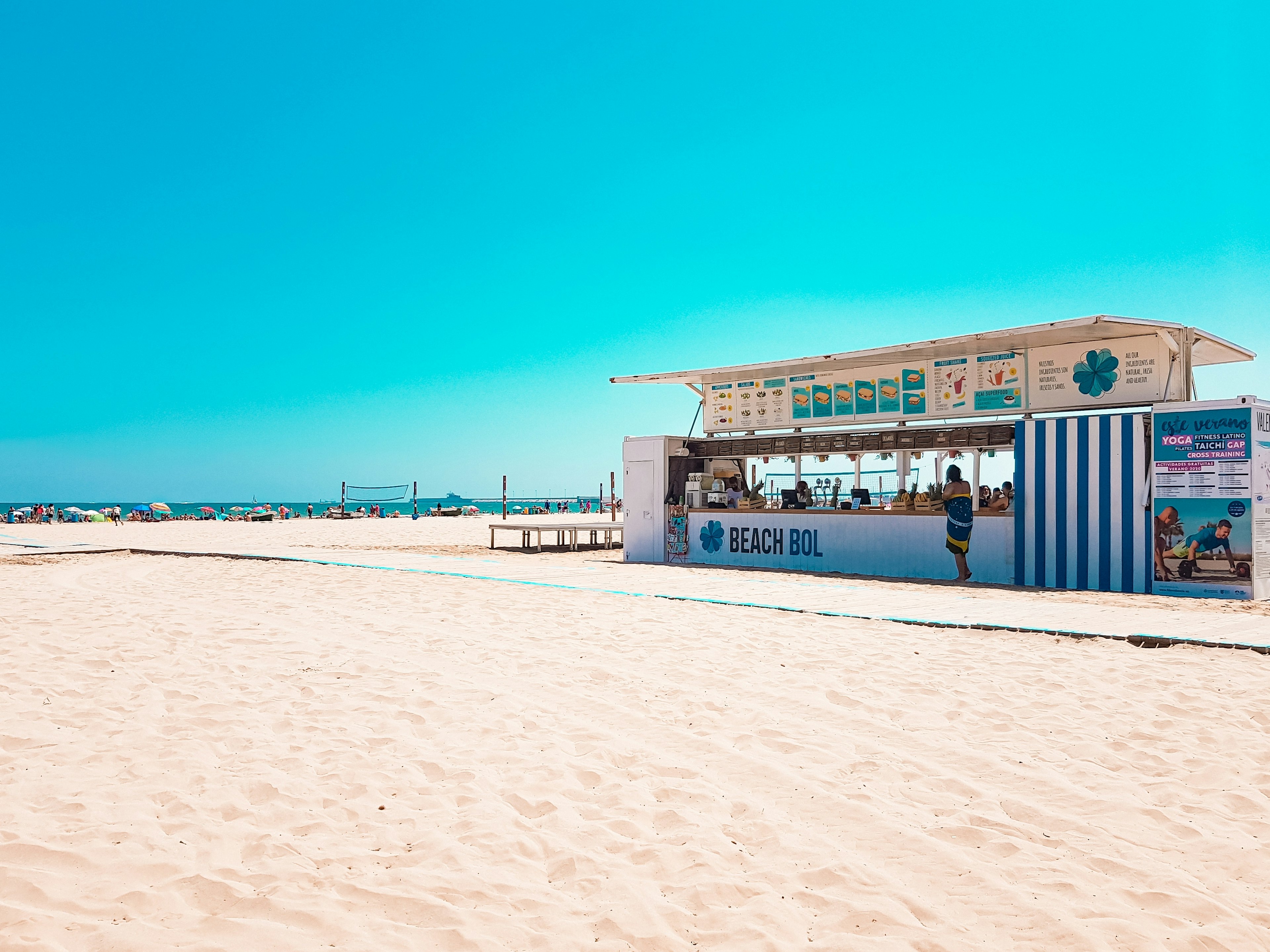 A beach bar serving snacks and drinks on a large sandy beach