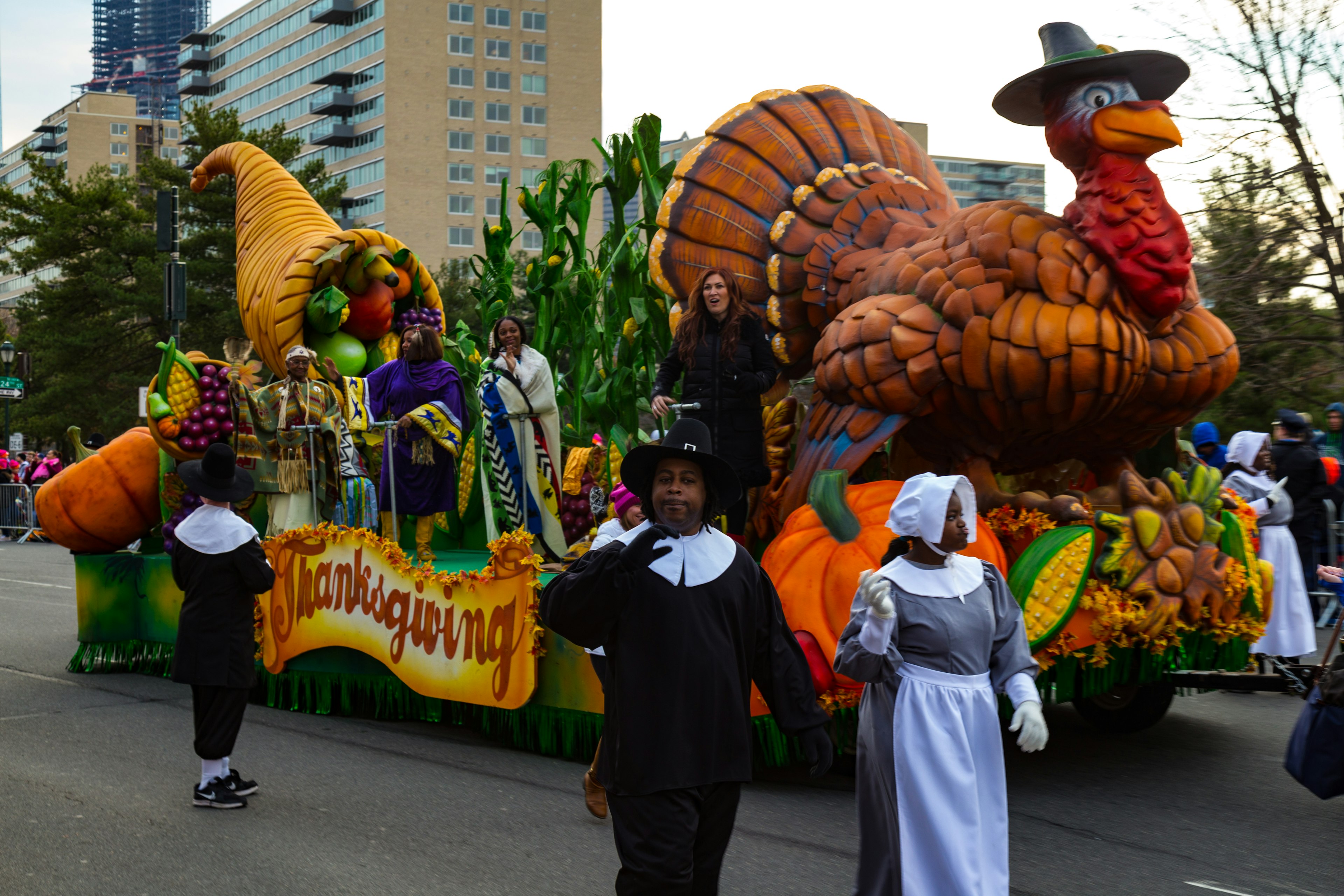 Pilgrims march alongside a turkey float in the annual Thanksgiving Day parade in Chicago