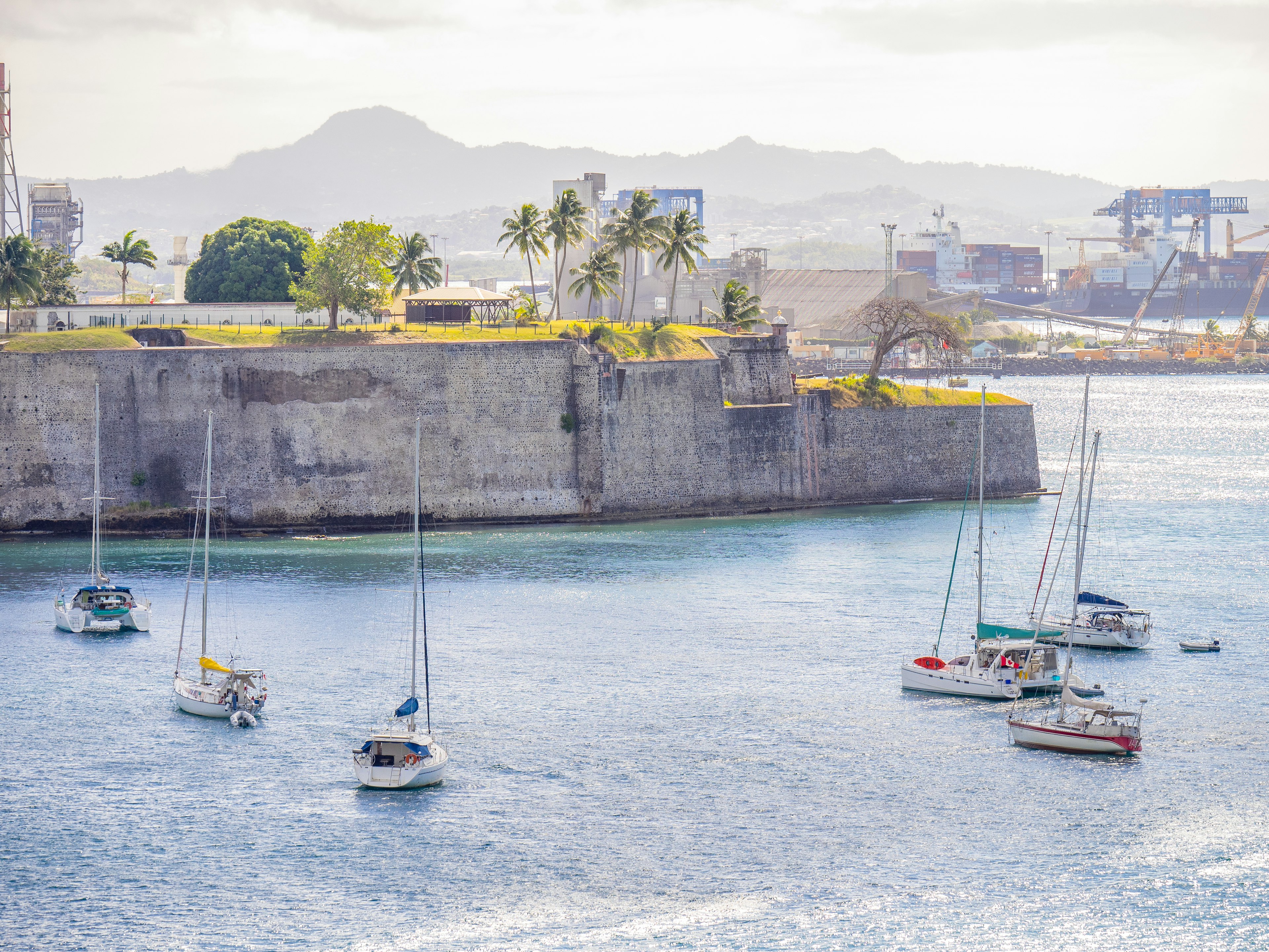 Sailboats in the harbor in front of the historic ramparts of Fort St-Louis, Fort-de-France, Martinique