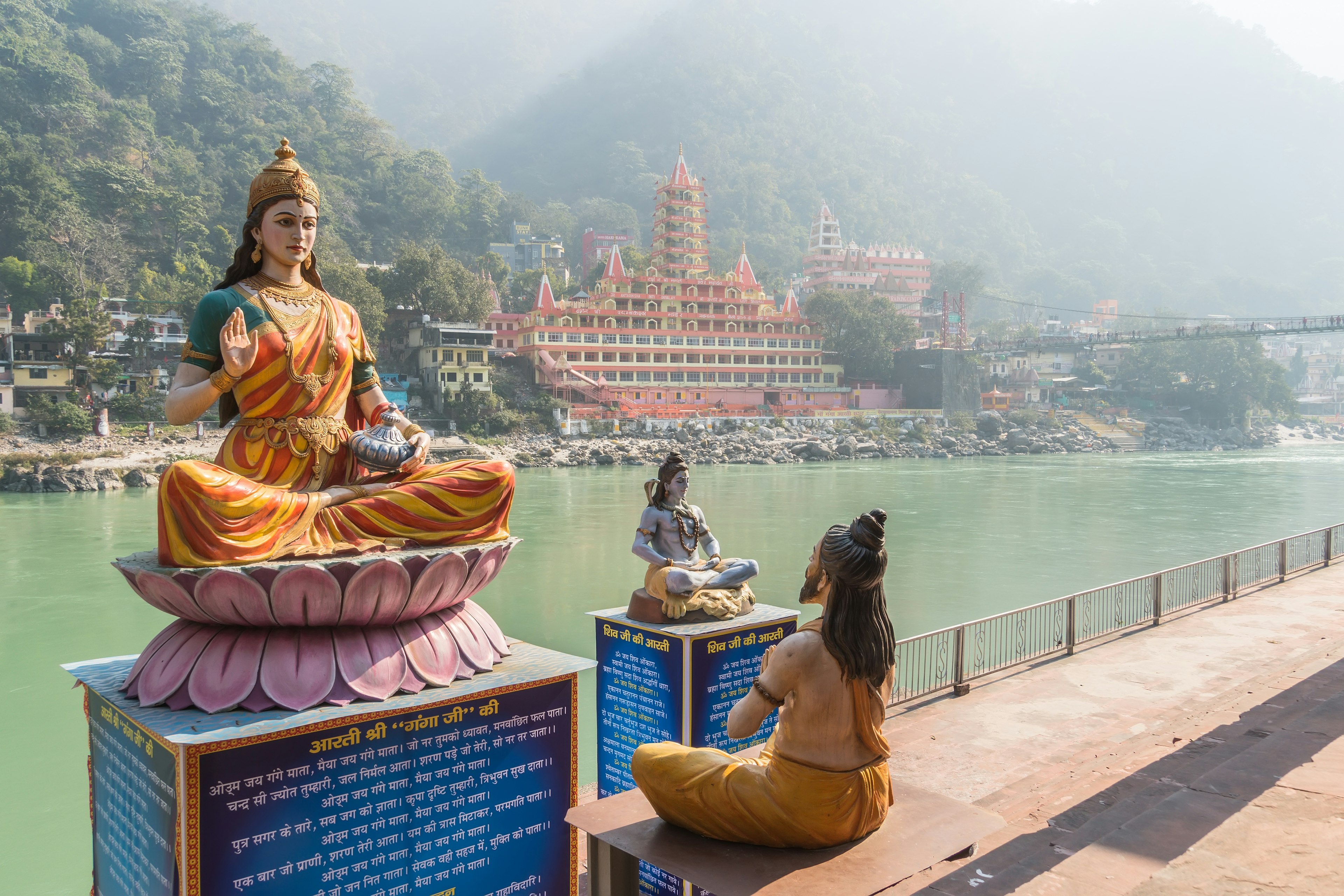 Sculptures of the Ganges, Shiva and the wise man on the river bank in Rishikesh.