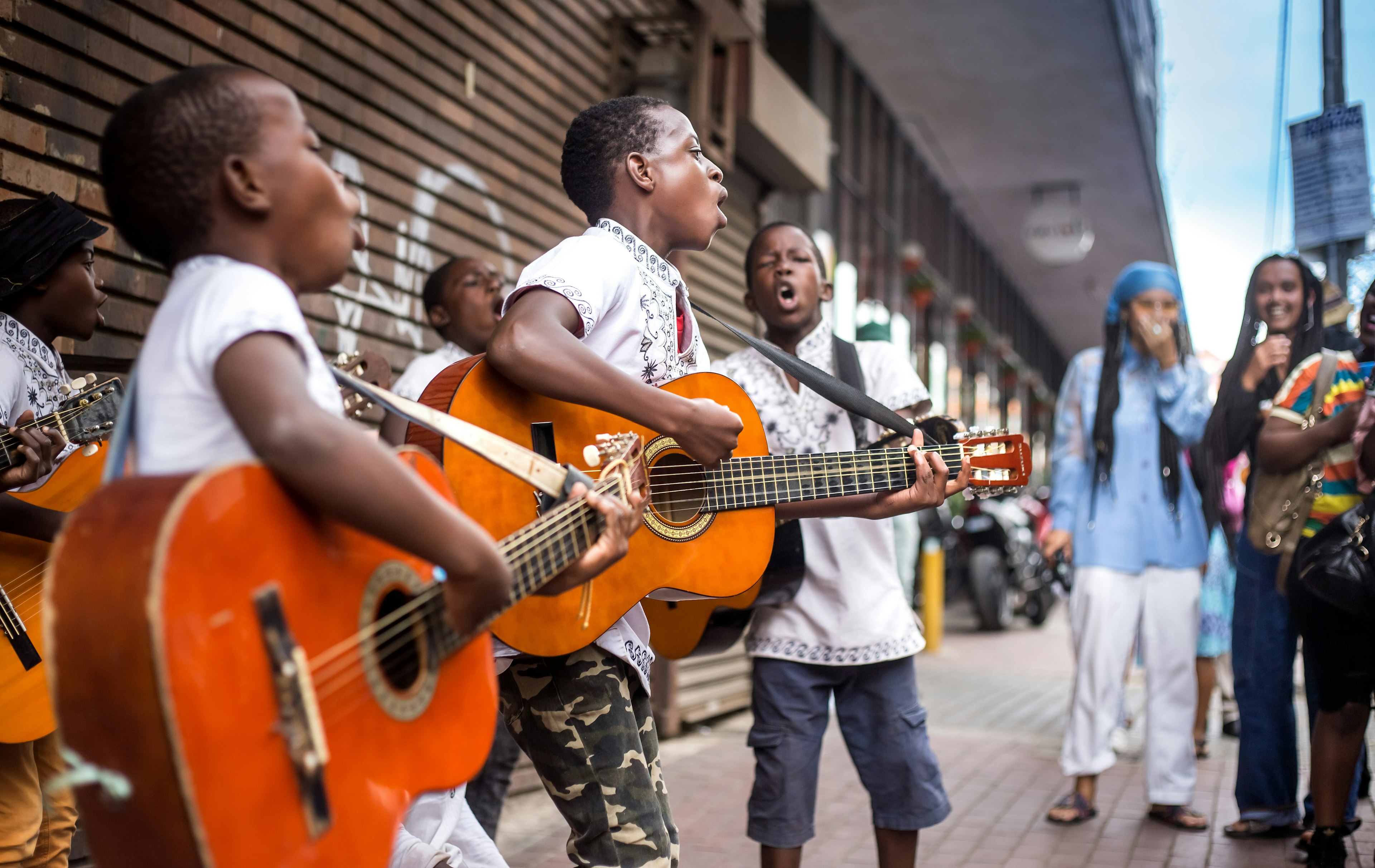 Buskers playing on the streets with guitars.