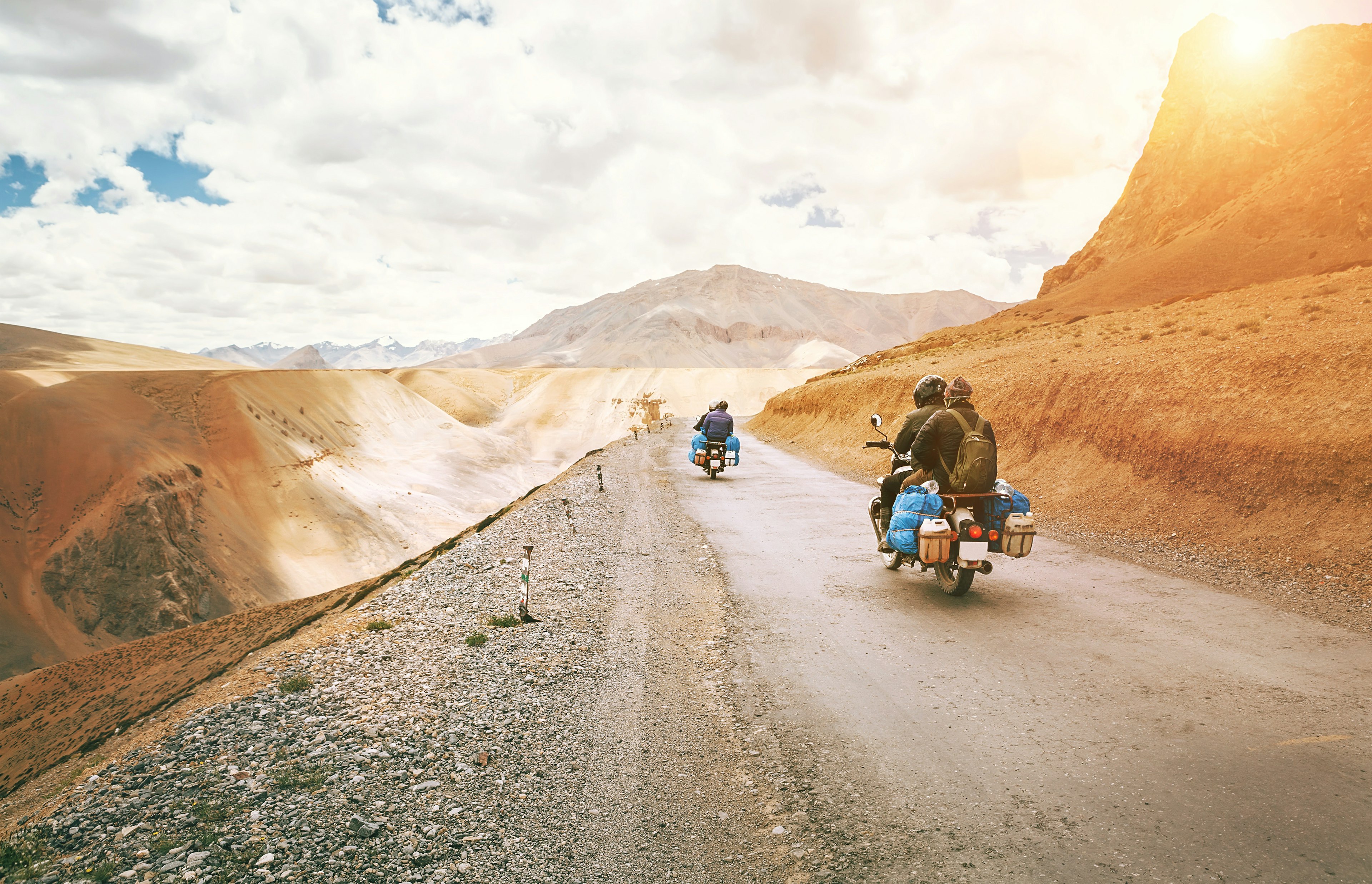 Motorcycle riders on high altitude dirt roads in Northern India.