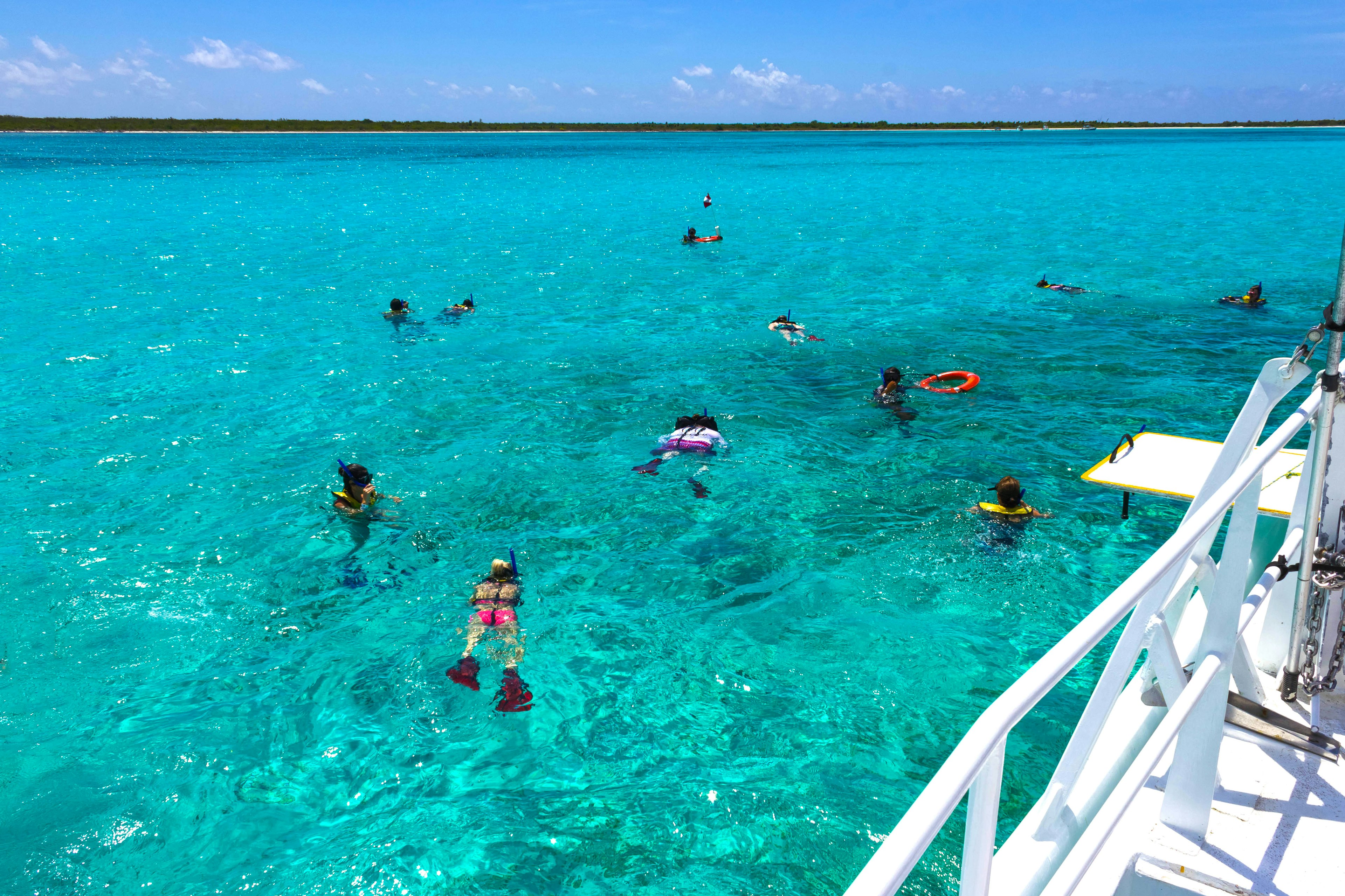 Group of people snorkelling on a party boat tour near Isla Cozumel, Mexico