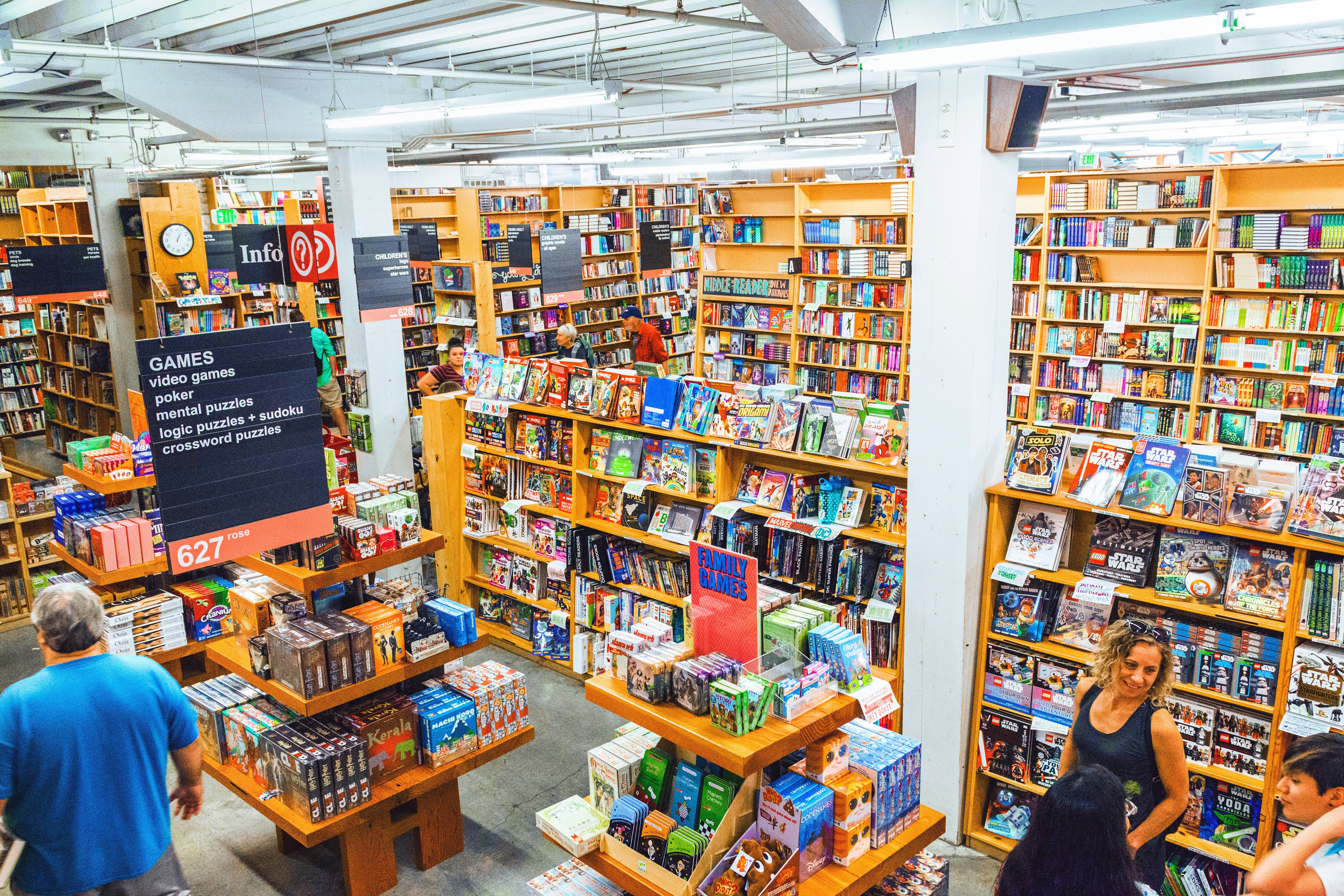 An overview shot of people browse shelves piled with books at Powell’s City of Books in Portland, Oregon, USA