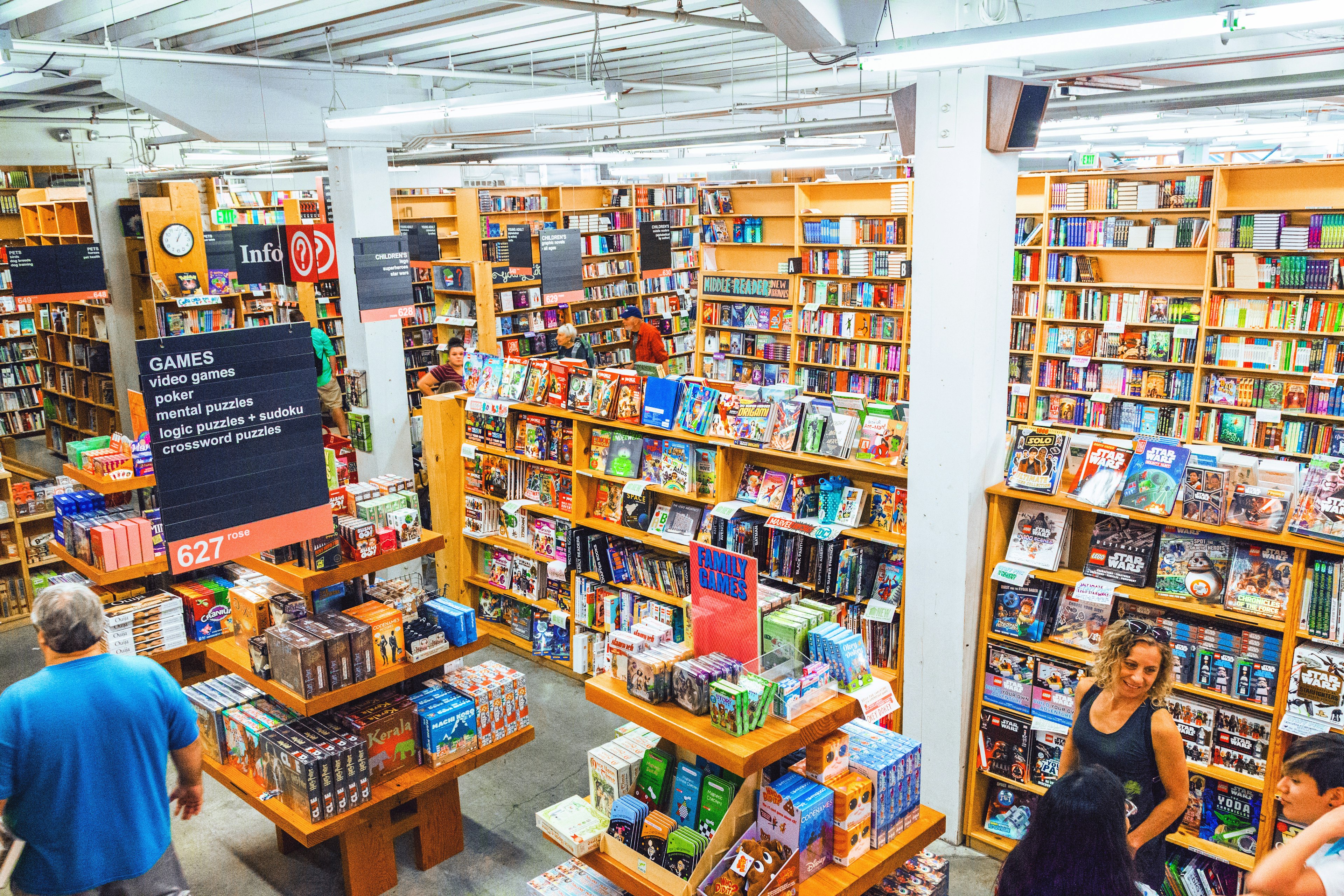 An overview shot of people browse shelves piled with books at Powell’s City of Books in Portland, Oregon, USA