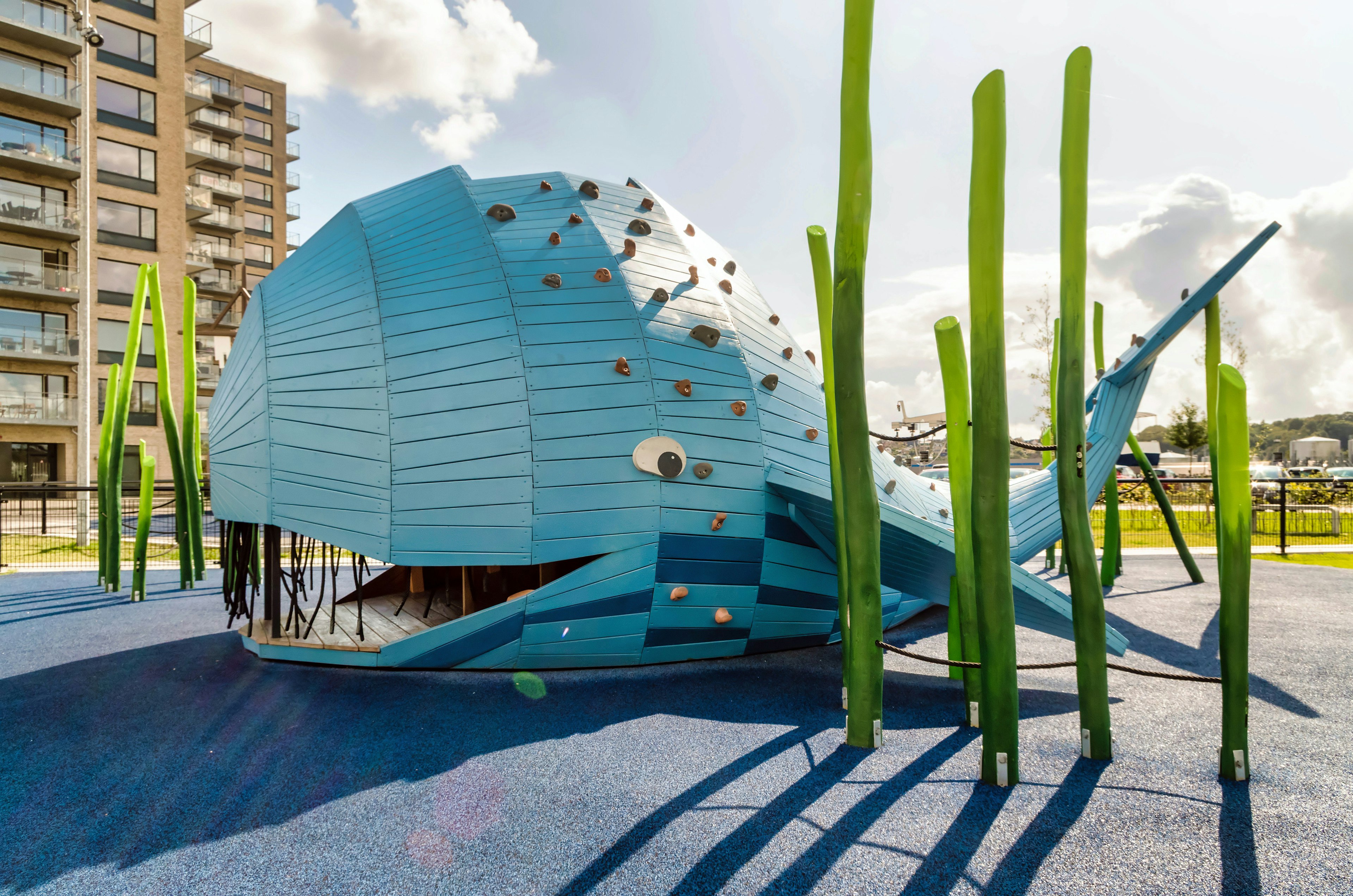 A bright blue whale-shaped installation in a children's playground in Vejle, Denmark.