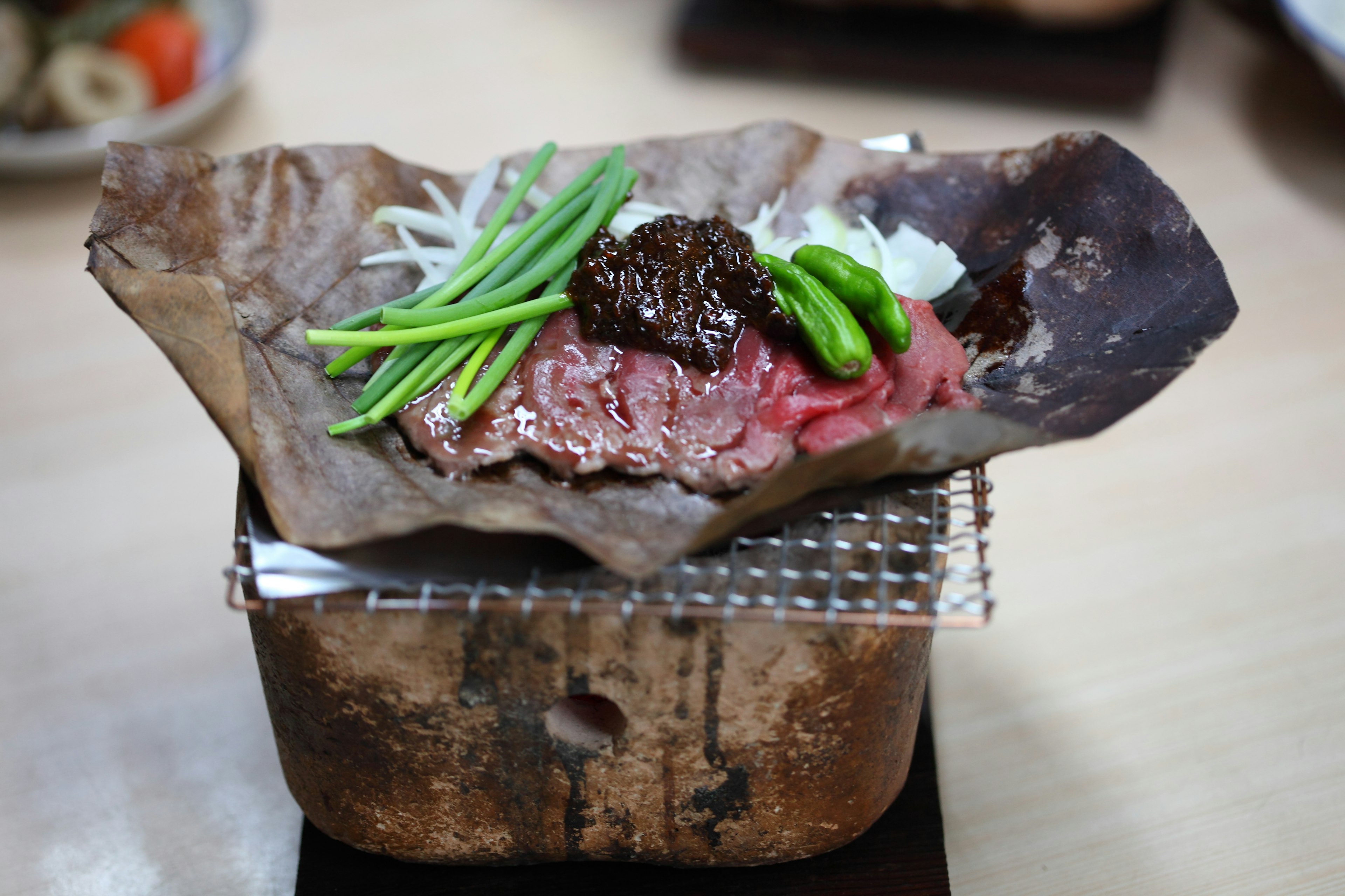 Hoba miso cooking on a table.