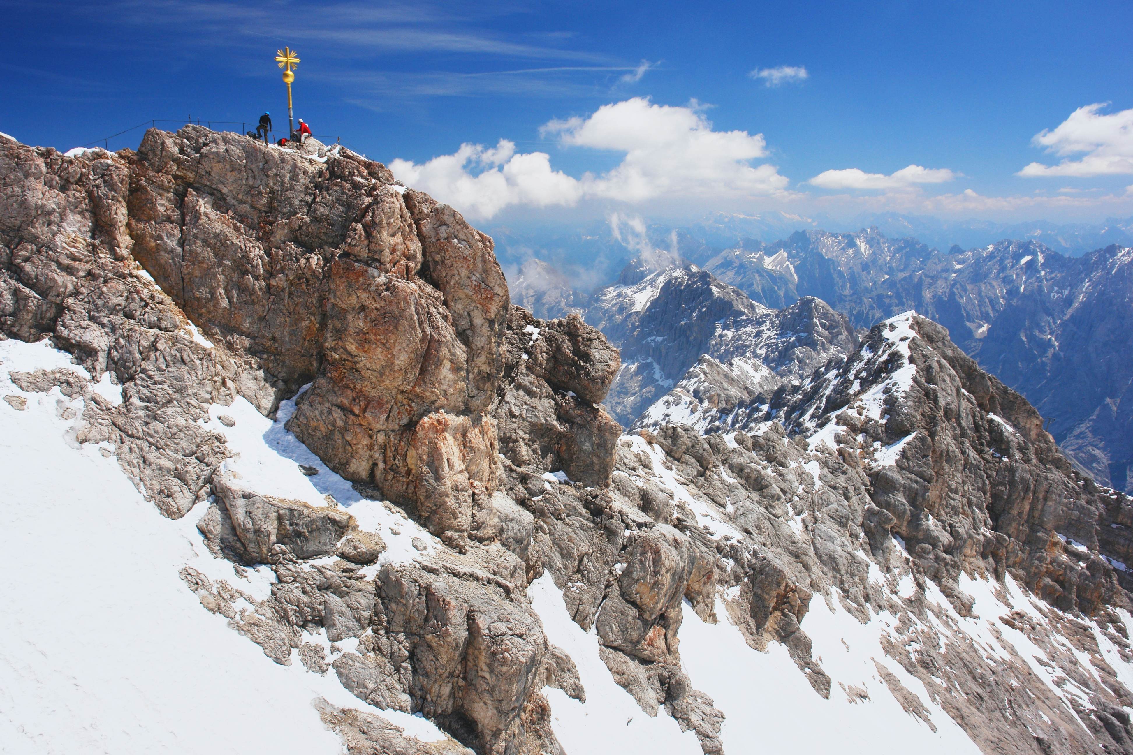 Walkers at the summit of Zugspitze, the highest peak in the Bavarian Alps, Germany.