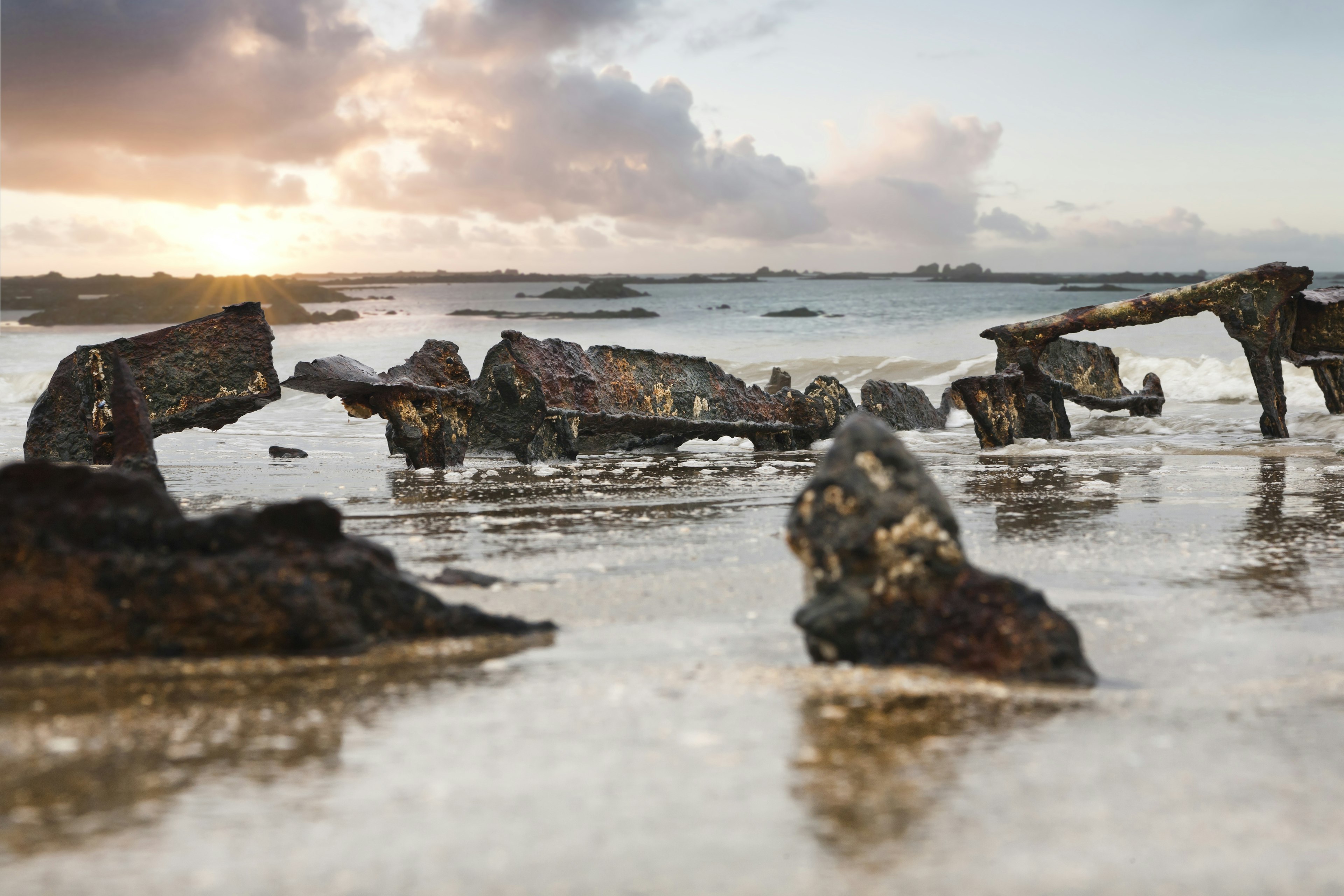 Dusk falls over the skeleton of an old armoured vehicle in the water at Utah Beach in Normandy