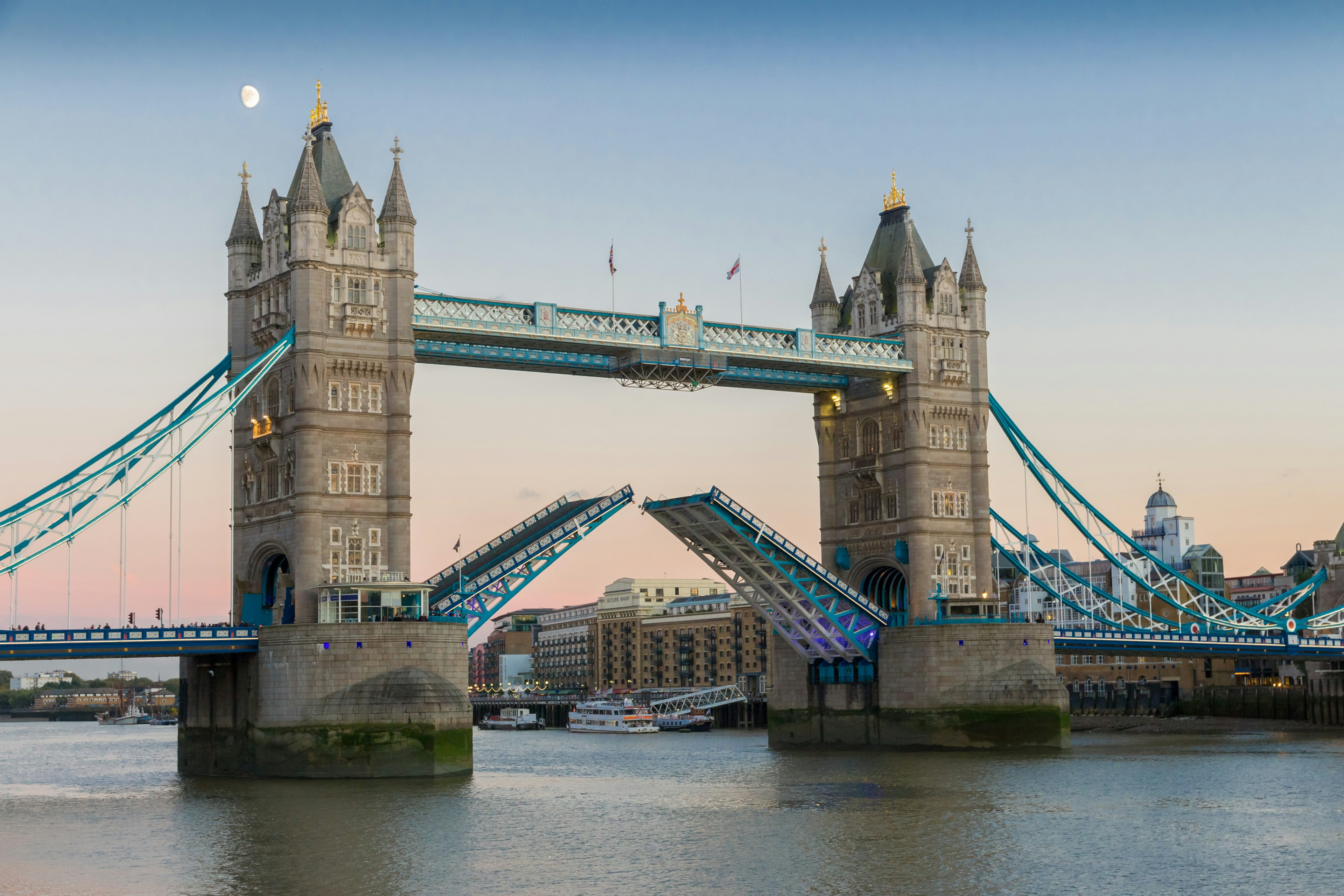 View on world famous London Tower Bridge with the bridge open for ship traffic shortly before sunset on a clear summer evening