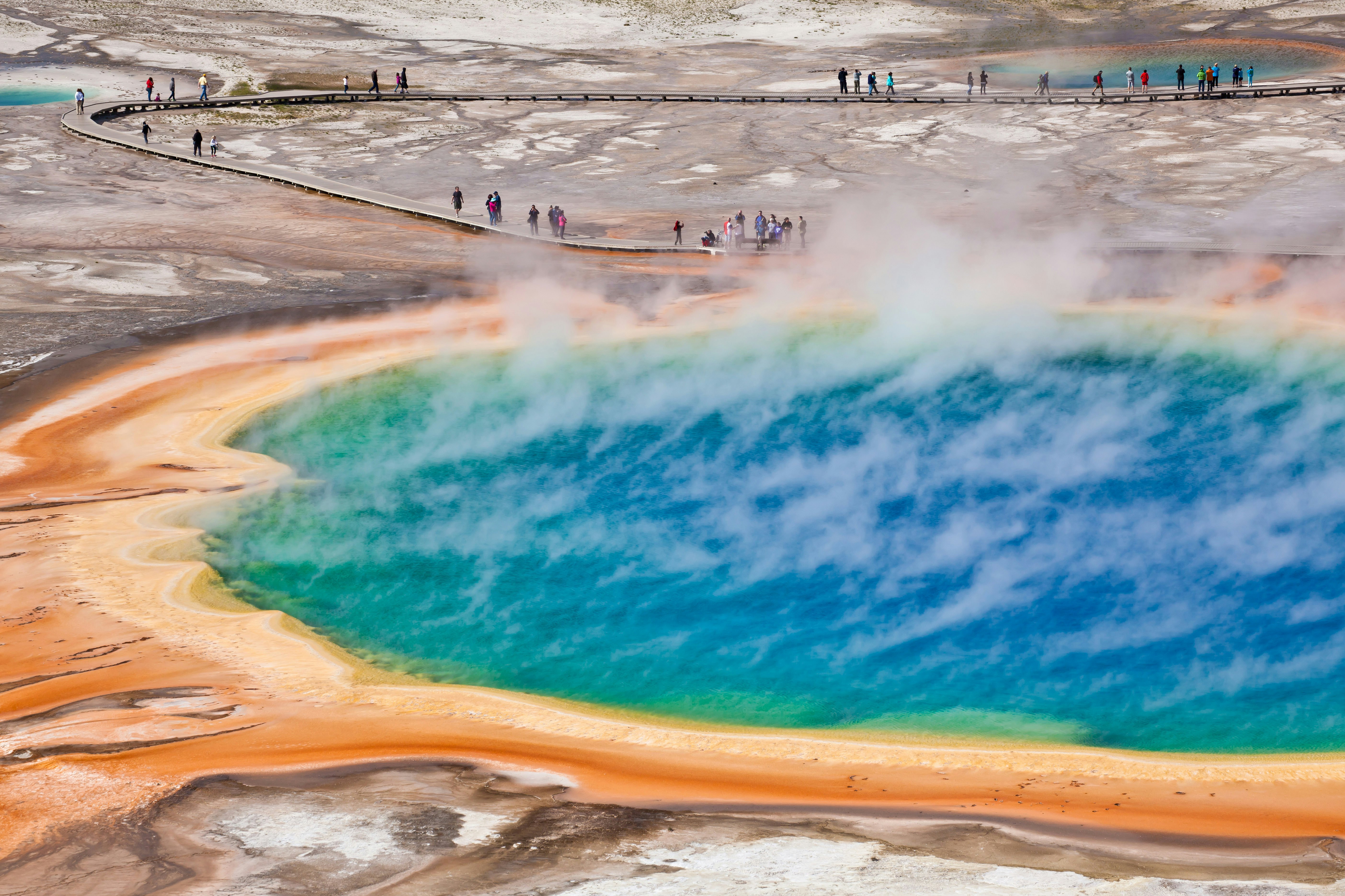 Steaming rises from the Grand Prismatic Geyser as people watch from a nearby boardway at Yellowstone National Park