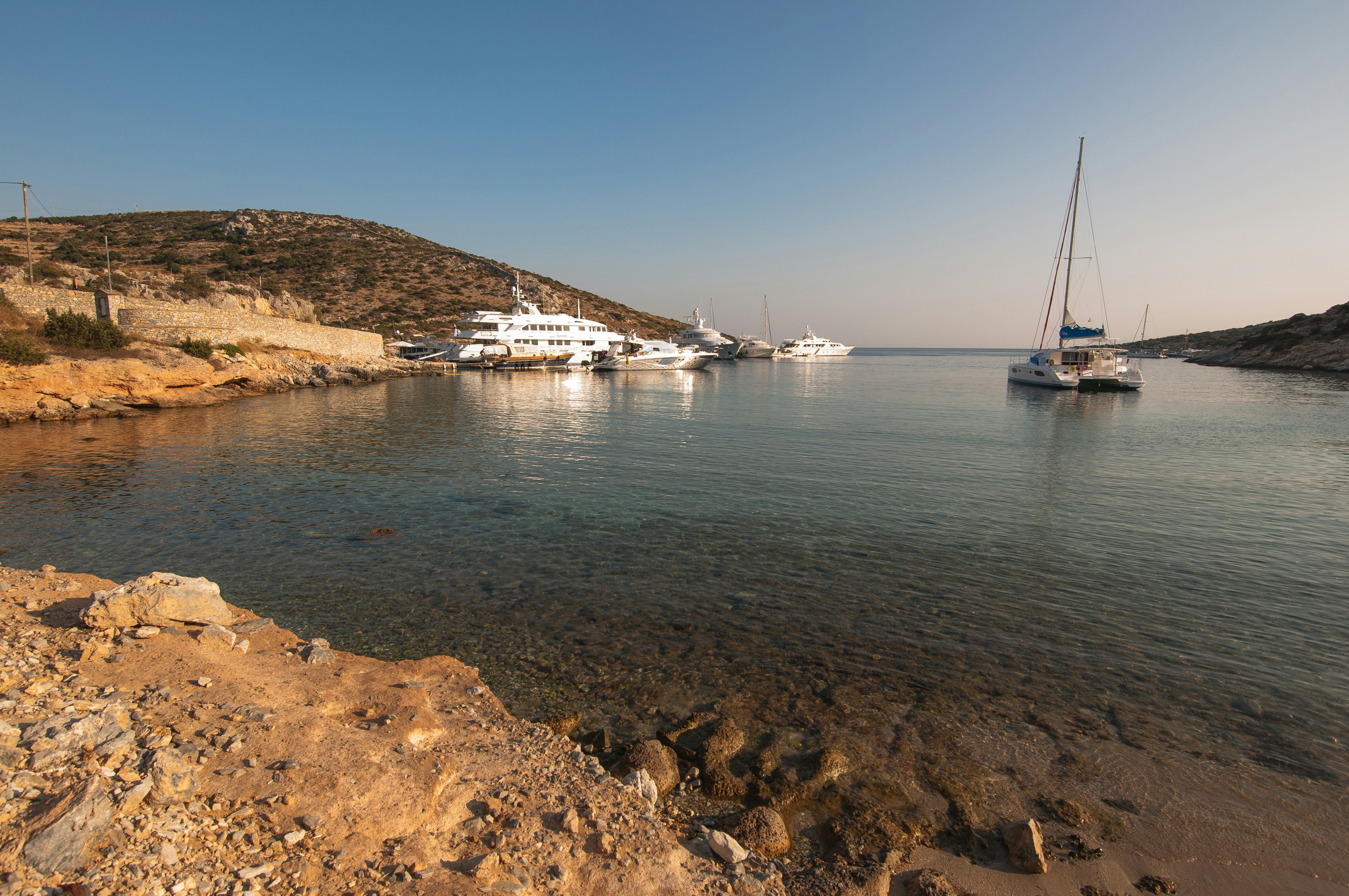 Sailing boats docked in a quiet bay at Schinousa island