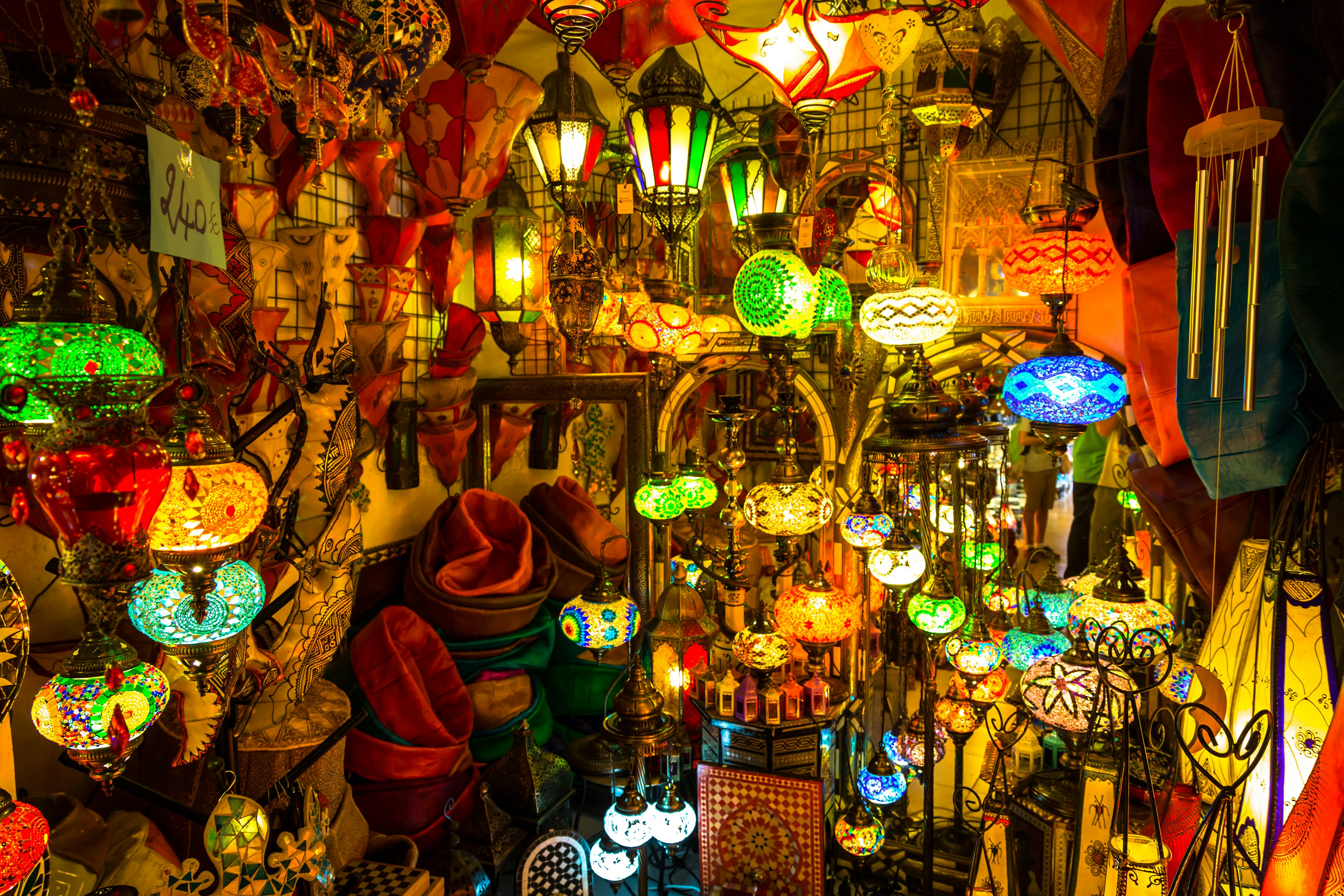 Dozens of colourful lamps glowing in a stall.