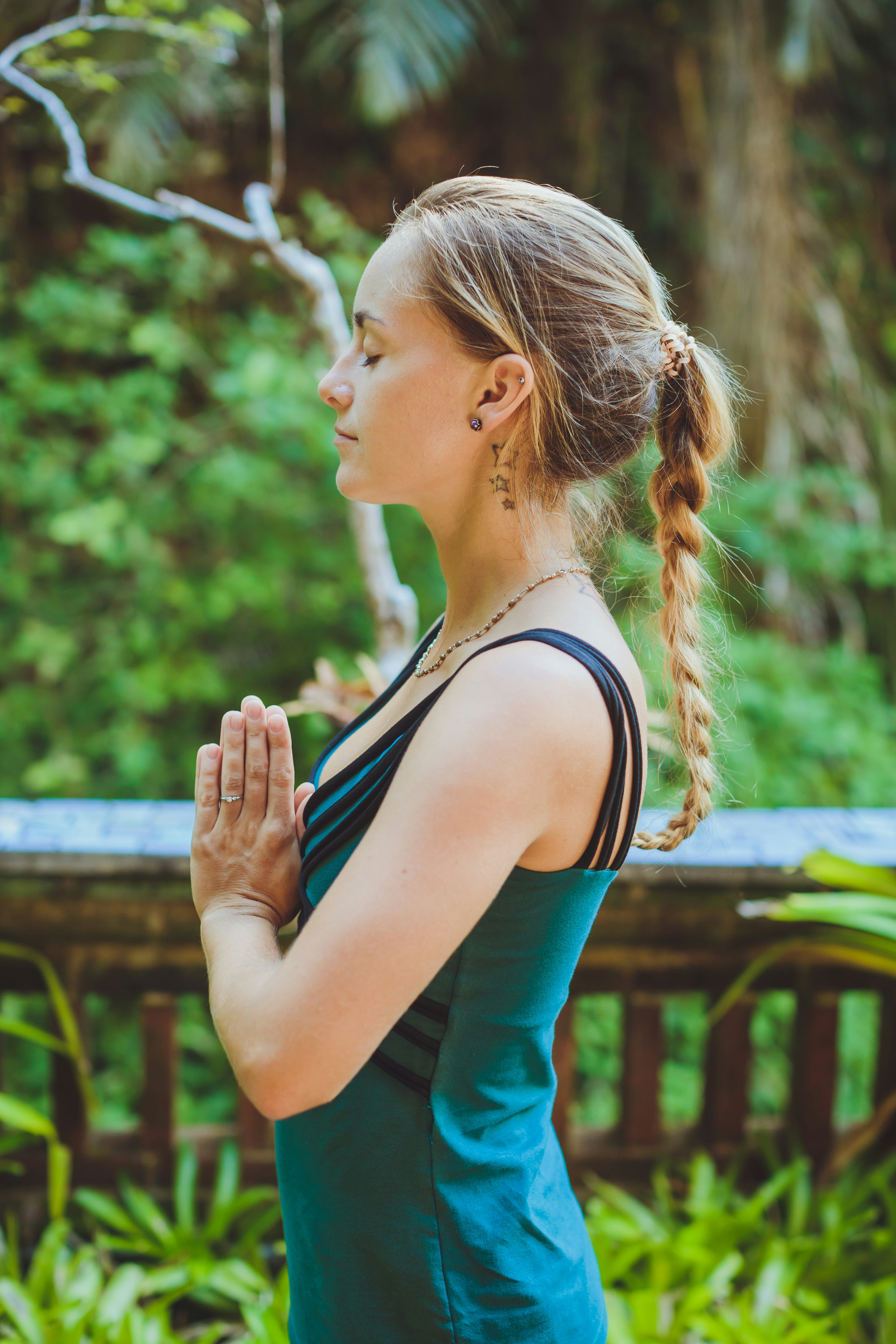 Young woman doing yoga outside in natural environment.