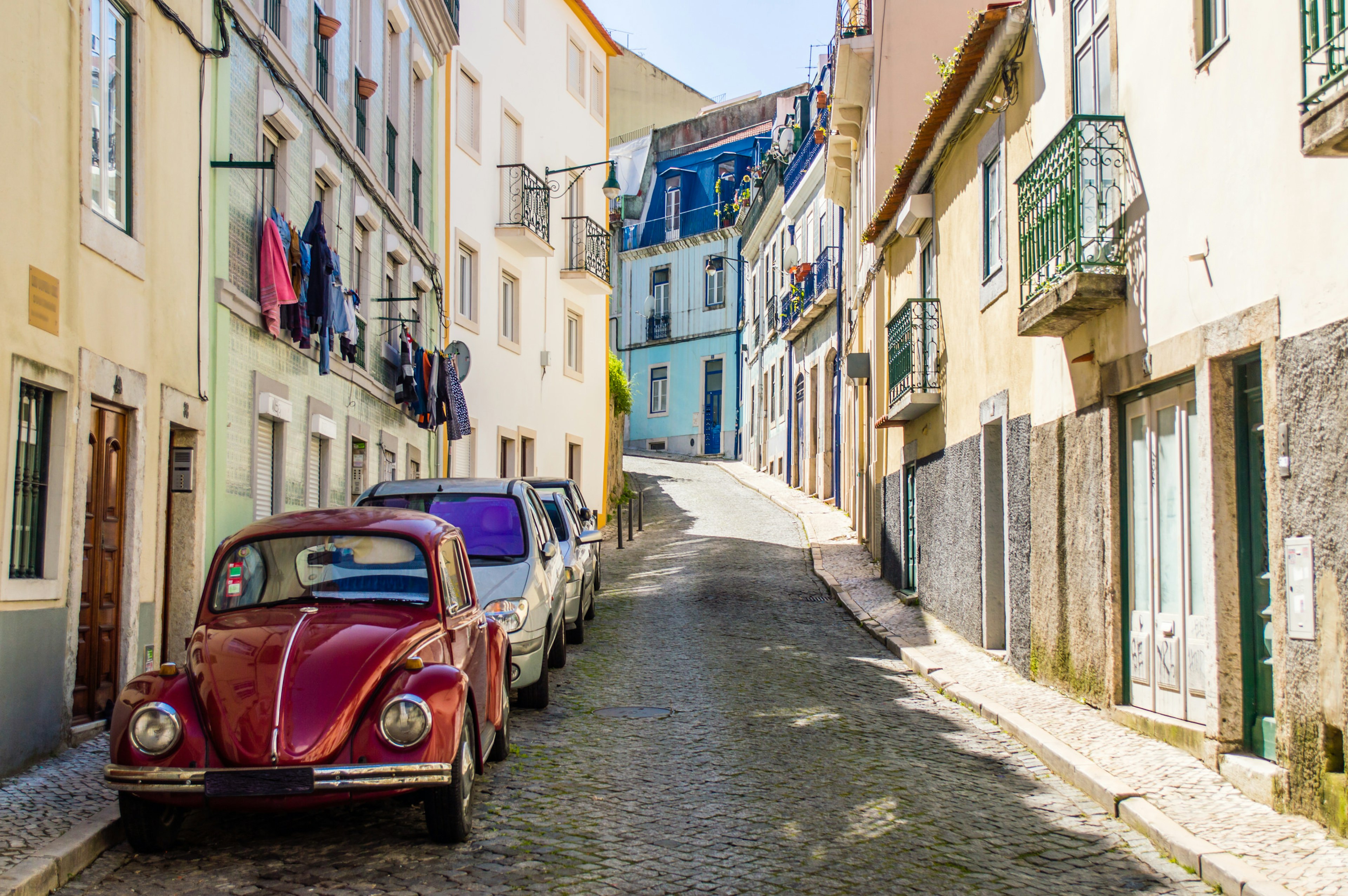 Portuguese street with old classic vintage VW beetle car in Lisbon, Portugal