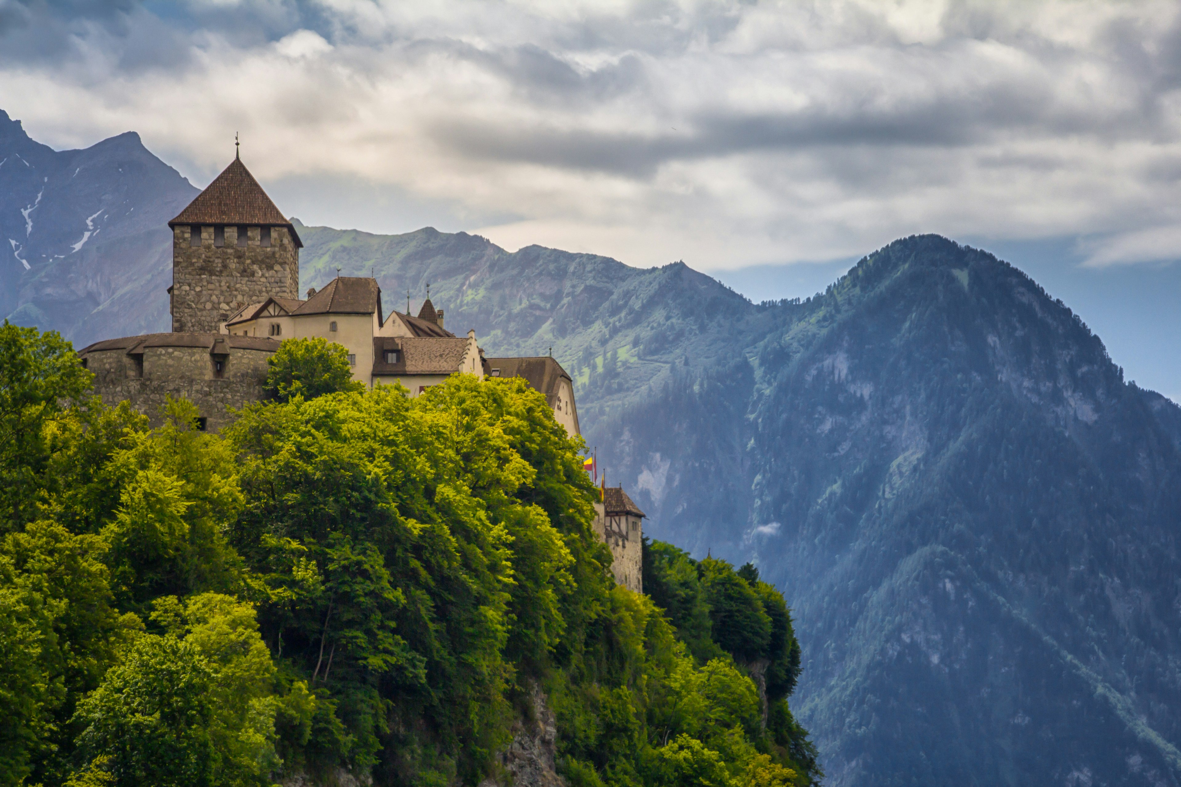 A view looking up to Vaduz castle and the towering Alps in the background