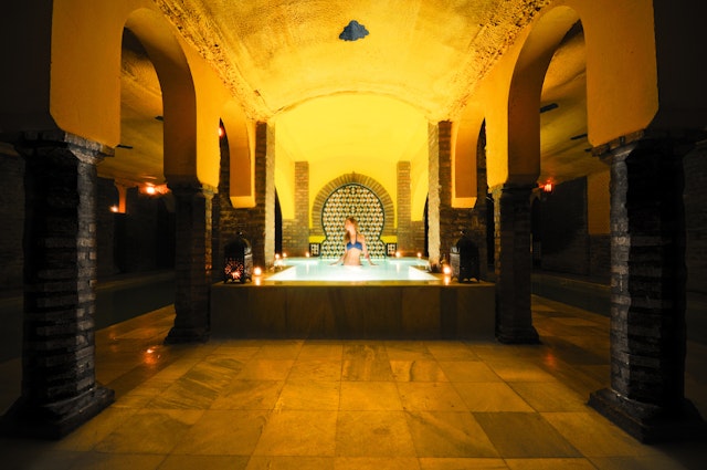 A woman taking a bath in the Arab baths (Hammam Al Ándalus Granada).