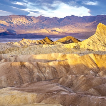 2148616692
Hikers on the slopes of Zabriskie Point at sunrise in Death Valley National Park in California, United States - stock photo
Hikers on the slopes of Zabriskie Point at sunrise in Death Valley National Park in California, United States