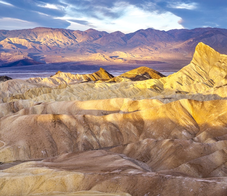 2148616692
Hikers on the slopes of Zabriskie Point at sunrise in Death Valley National Park in California, United States - stock photo
Hikers on the slopes of Zabriskie Point at sunrise in Death Valley National Park in California, United States
