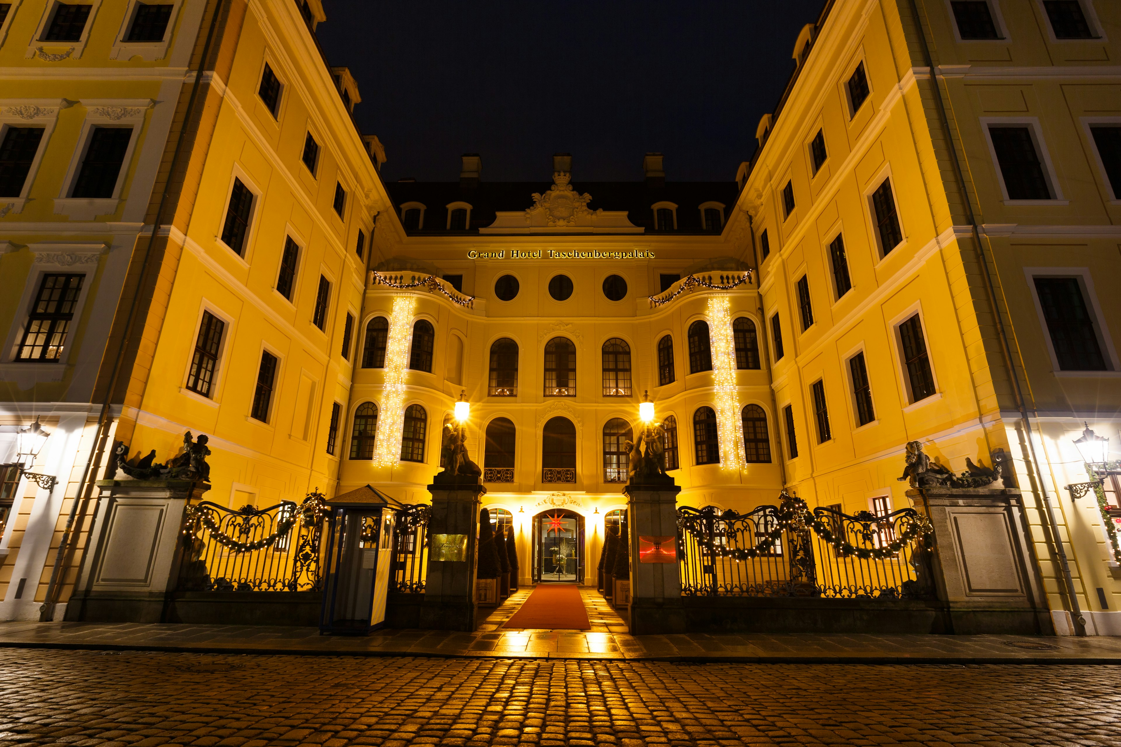 The exterior of a grand hotel lit up at night