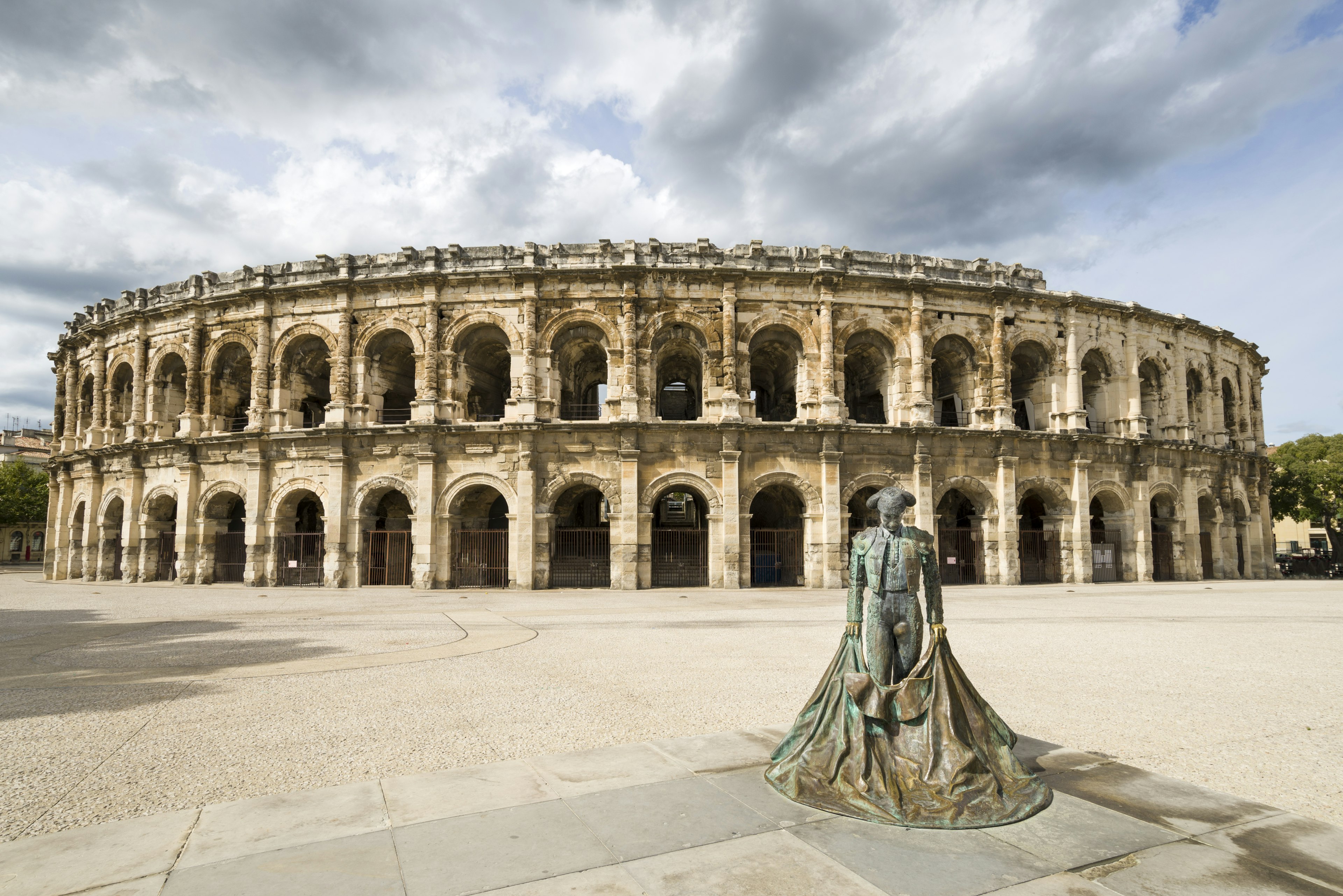 The Ampitheater in Nimes, with cloudy skies above.