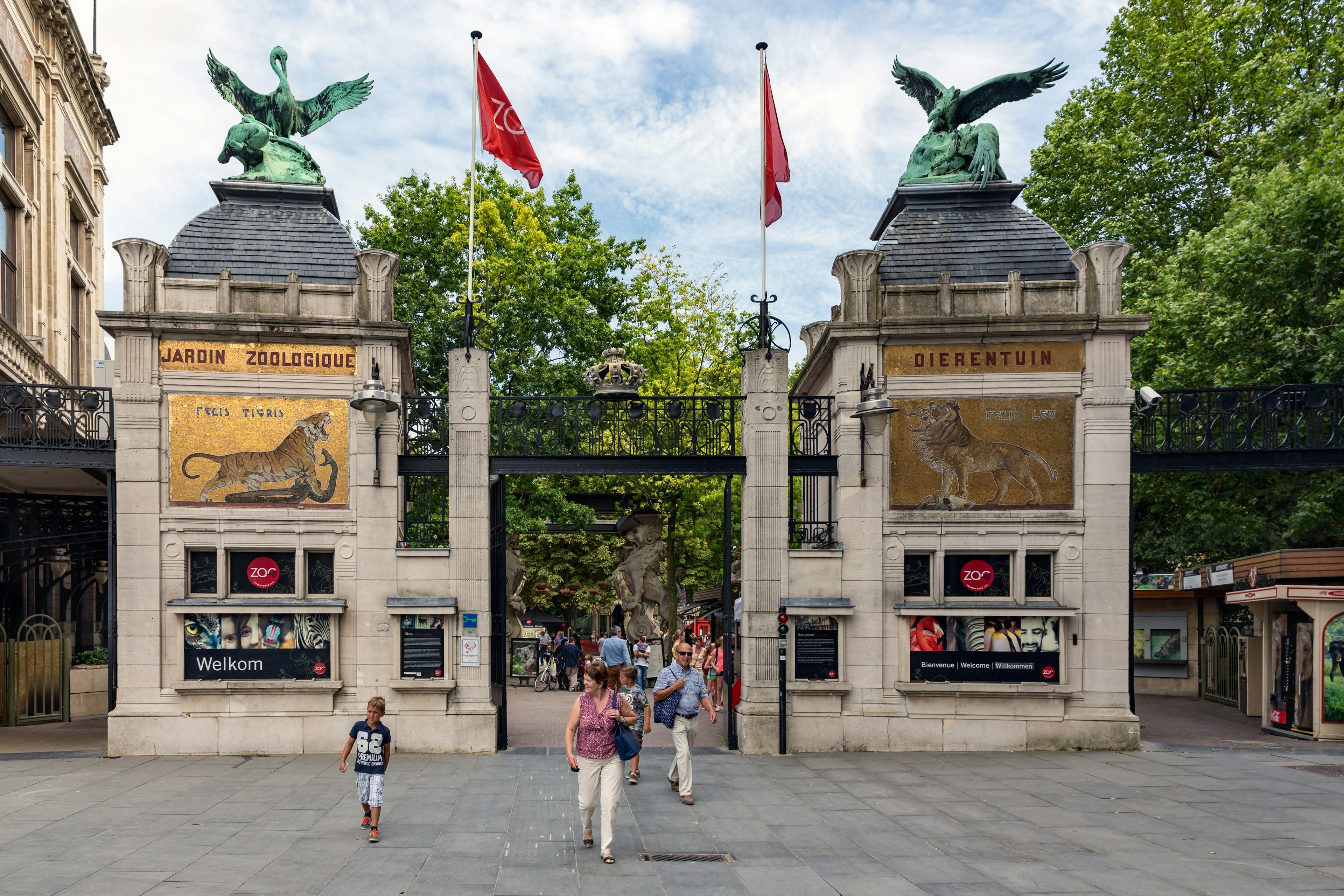 A family walk out through the large gateway to a zoo