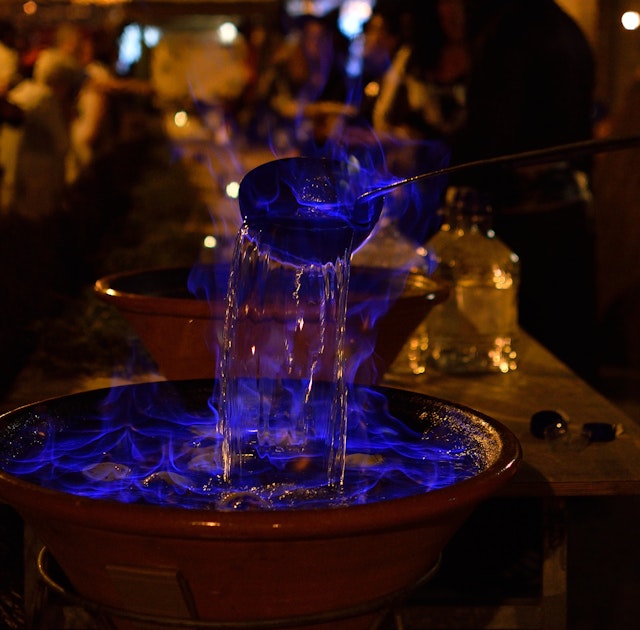 A bowl of traditional Galician queimada punch set alight in a Spanish restaurant